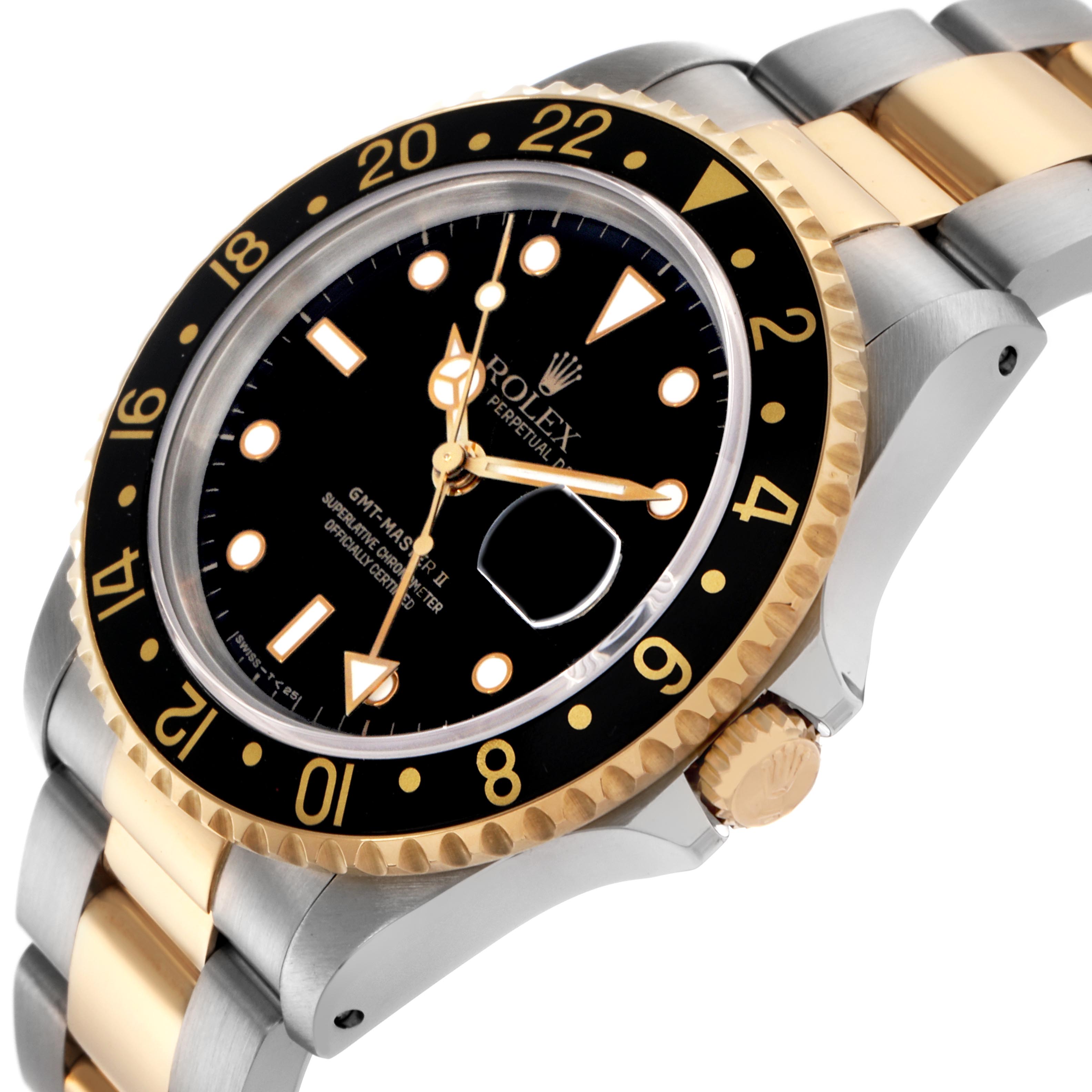 The Rolex GMT-Master 16713LN Men
s Steel and Gold (two tone) Black Dial 16713LN Men
s Steel and Gold (two tone) Black Dial watch is shown at an oblique angle, highlighting the bezel, crown, and part of the bracelet.