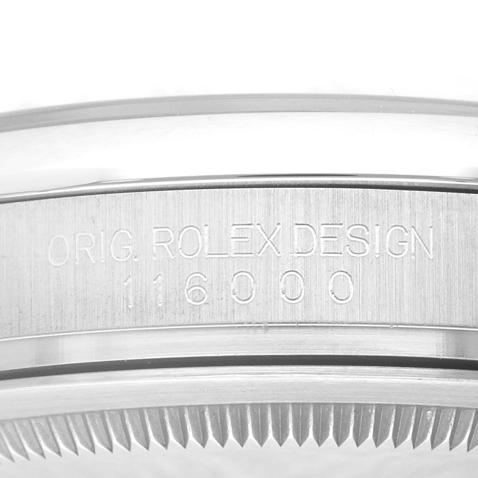 The image shows a close-up of the side of a Rolex Oyster Perpetual 116000 Men
s Stainless Steel Blue Dial 116000 Men
s Stainless Steel Blue Dial watch, highlighting the engraved design and model number.