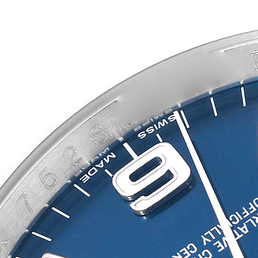 This close-up angle of the Rolex Oyster Perpetual 116000 Men
s Stainless Steel Blue Dial 116000 Men
s Stainless Steel Blue Dial watch showcases part of the blue dial and the "9" hour marker.