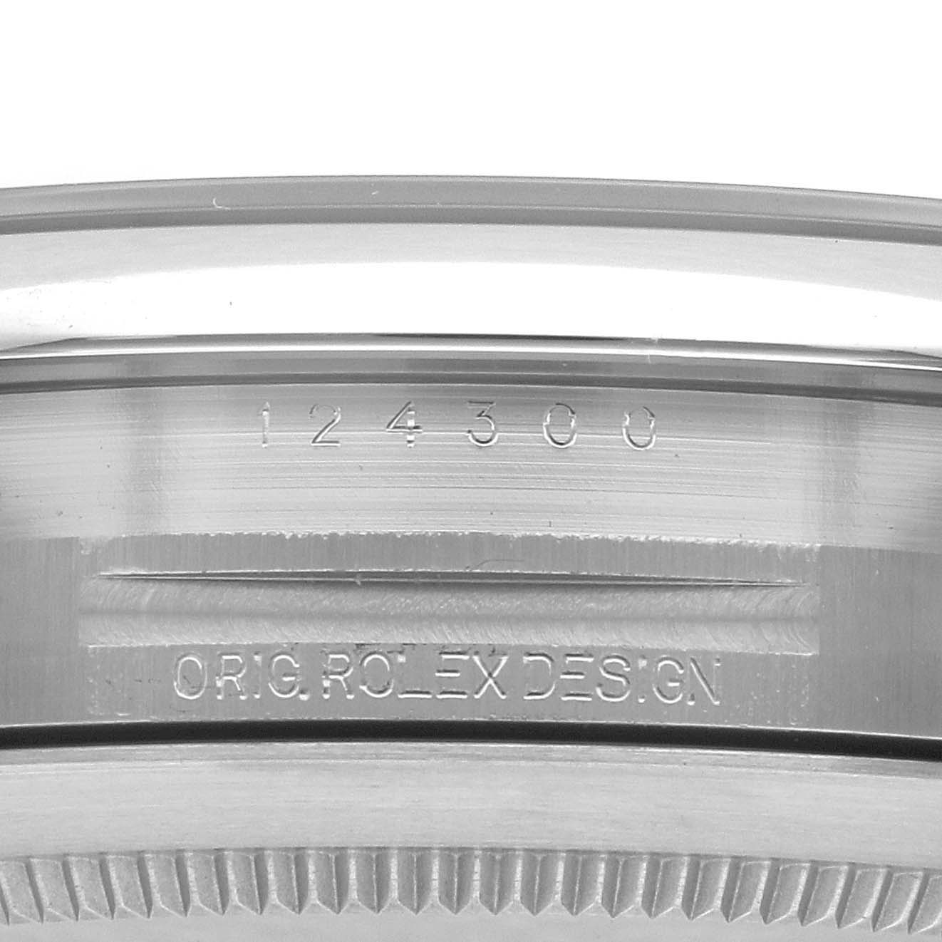 The image shows the side view of a Rolex Oyster Perpetual 124300 Men's Stainless Steel Silver Dial 124300 Men's Stainless Steel Silver Dial watch case, highlighting the engraving of "124300" and "ORIG ROLEX DESIGN".