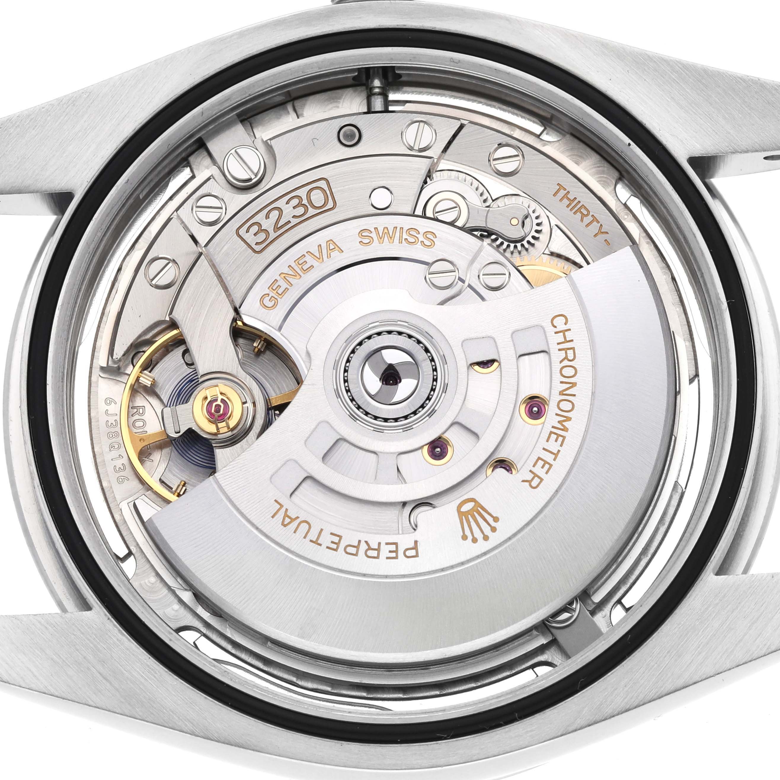 The image shows the movement of a Rolex Oyster Perpetual 124300 Men's Stainless Steel Silver Dial 124300 Men's Stainless Steel Silver Dial watch from the back, highlighting the rotor and inner mechanisms.