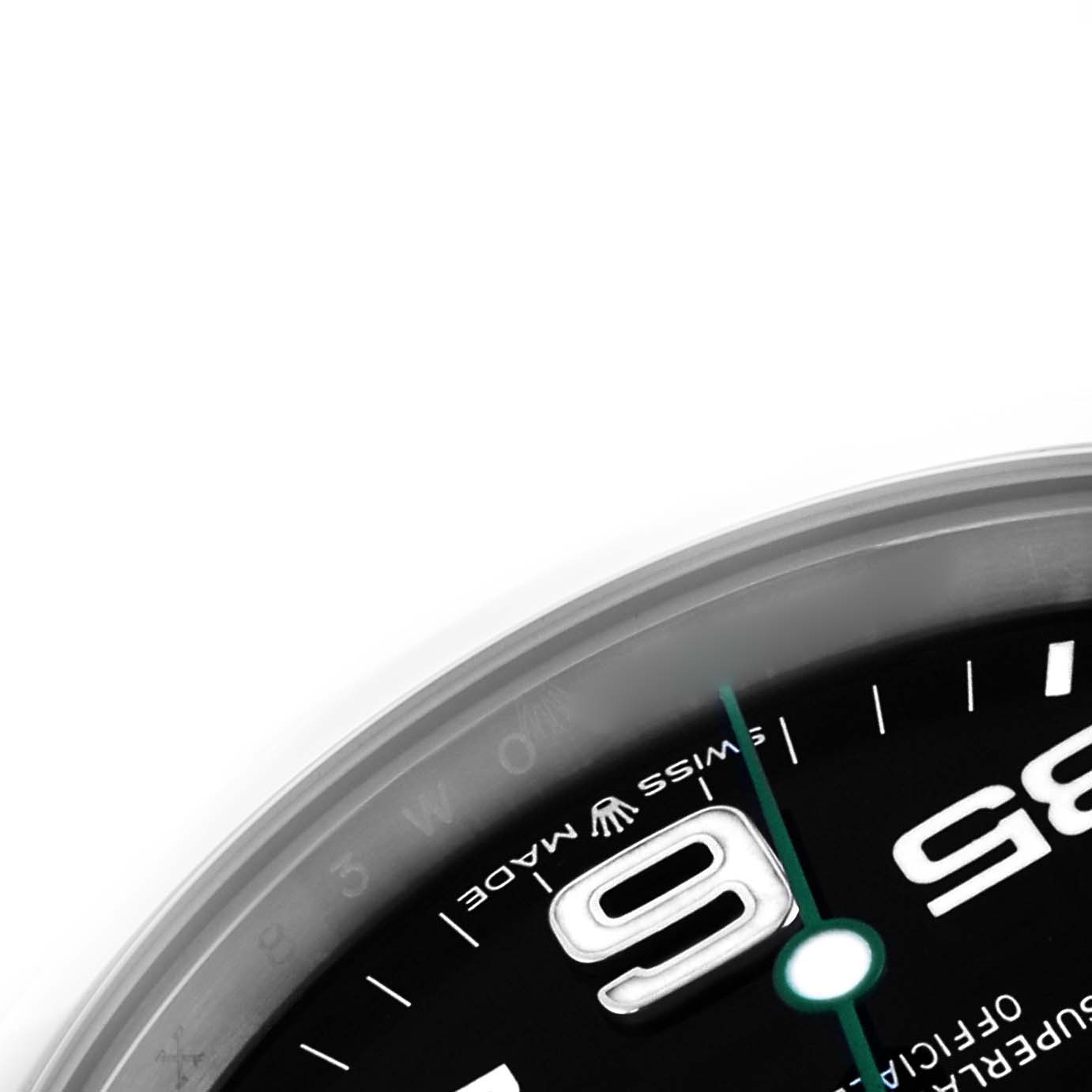 The image shows a partial view of the Rolex Air-King 126900 Men's Stainless Steel Black Dial 126900 Men's Stainless Steel Black Dial watch, focusing on the edge, with the number "6" and part of the dial visible.