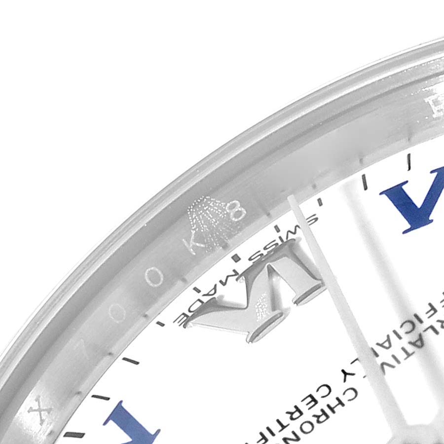 The image shows a close-up of the white watch face and crystal of a Rolex Mid-Size 177200 Women
s Stainless Steel White Dial 177200 Women
s Stainless Steel White Dial model, including part of the Roman numerals.