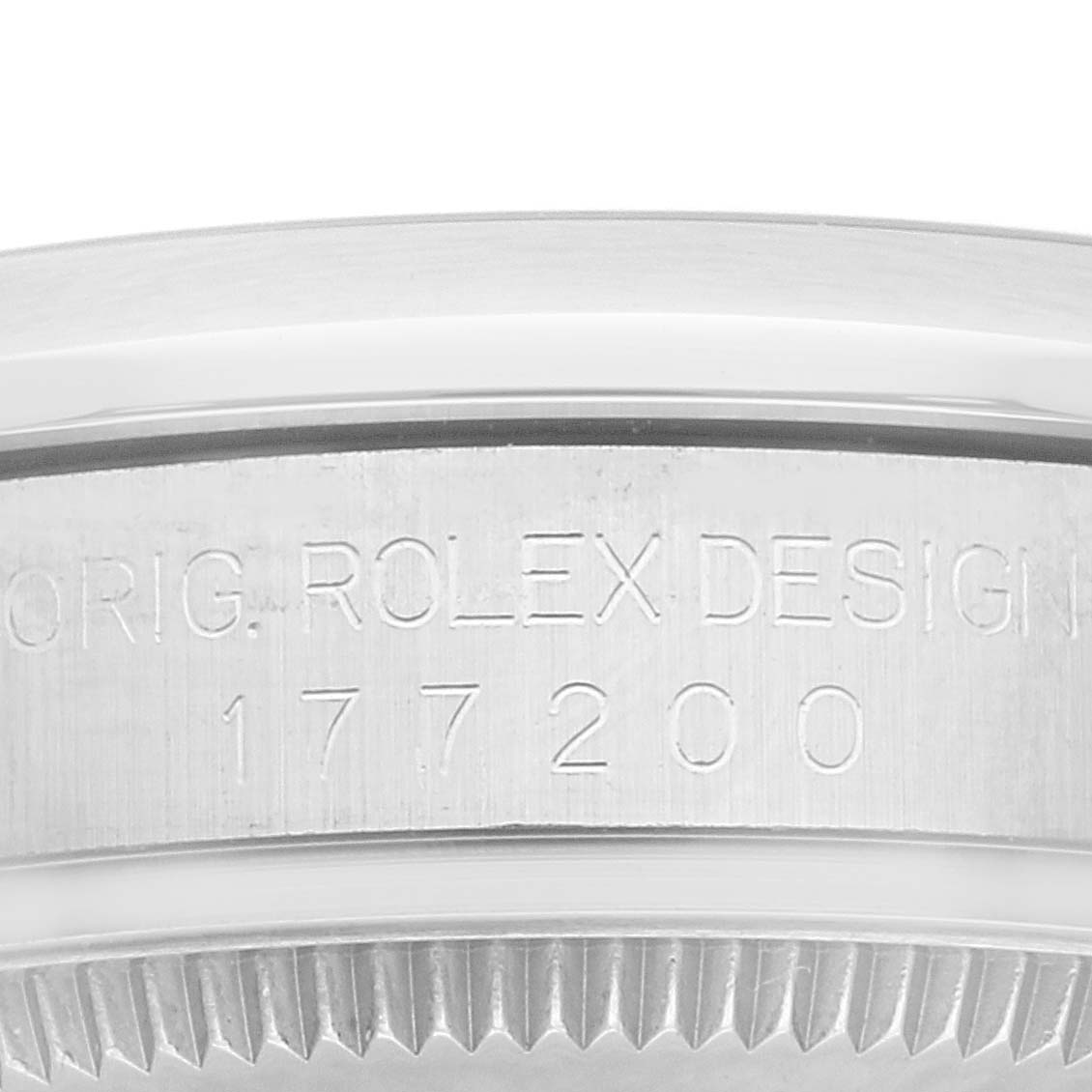 This image shows a close-up of the case back and rehaut of a Mid-Size Rolex watch, featuring the model number and engraving.