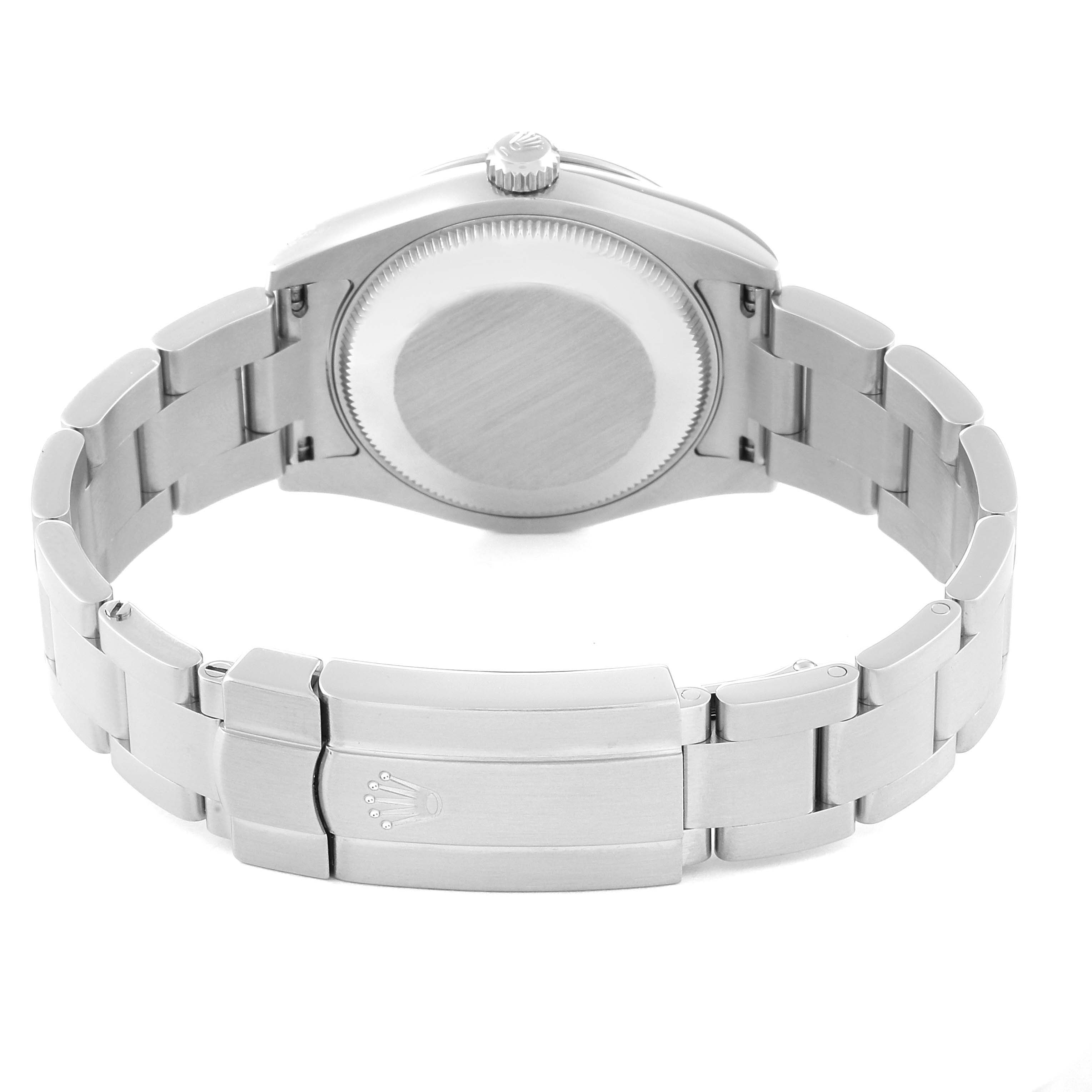 The image shows the back of a Mid-Size Rolex watch, focusing on the case back, crown, and bracelet with the clasp.