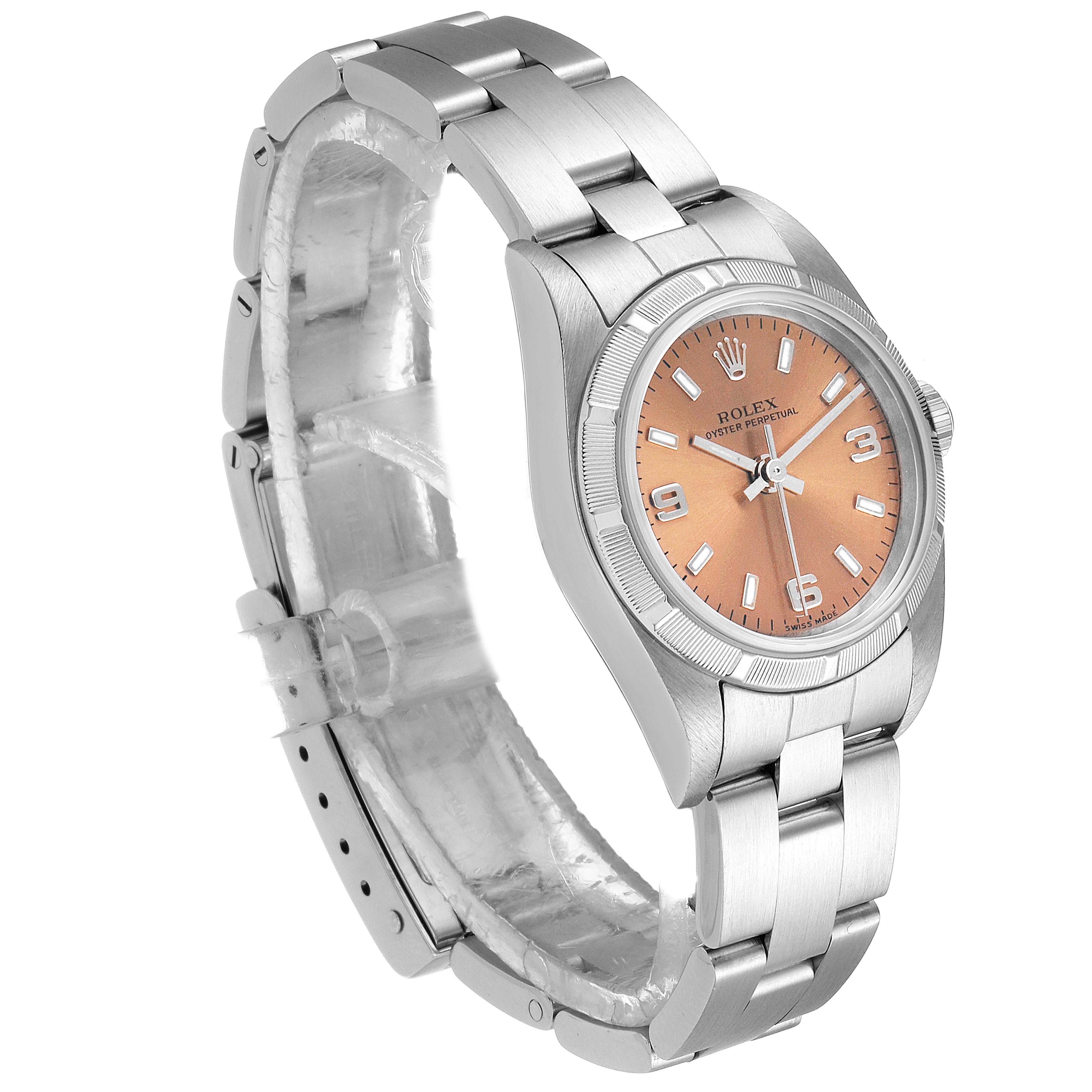 The Rolex Oyster Perpetual 76030 Women's Stainless Steel Pink Dial 76030 Women's Stainless Steel Pink Dial watch is shown at a slight angle, displaying the bracelet, case, crown, and peach-colored dial.