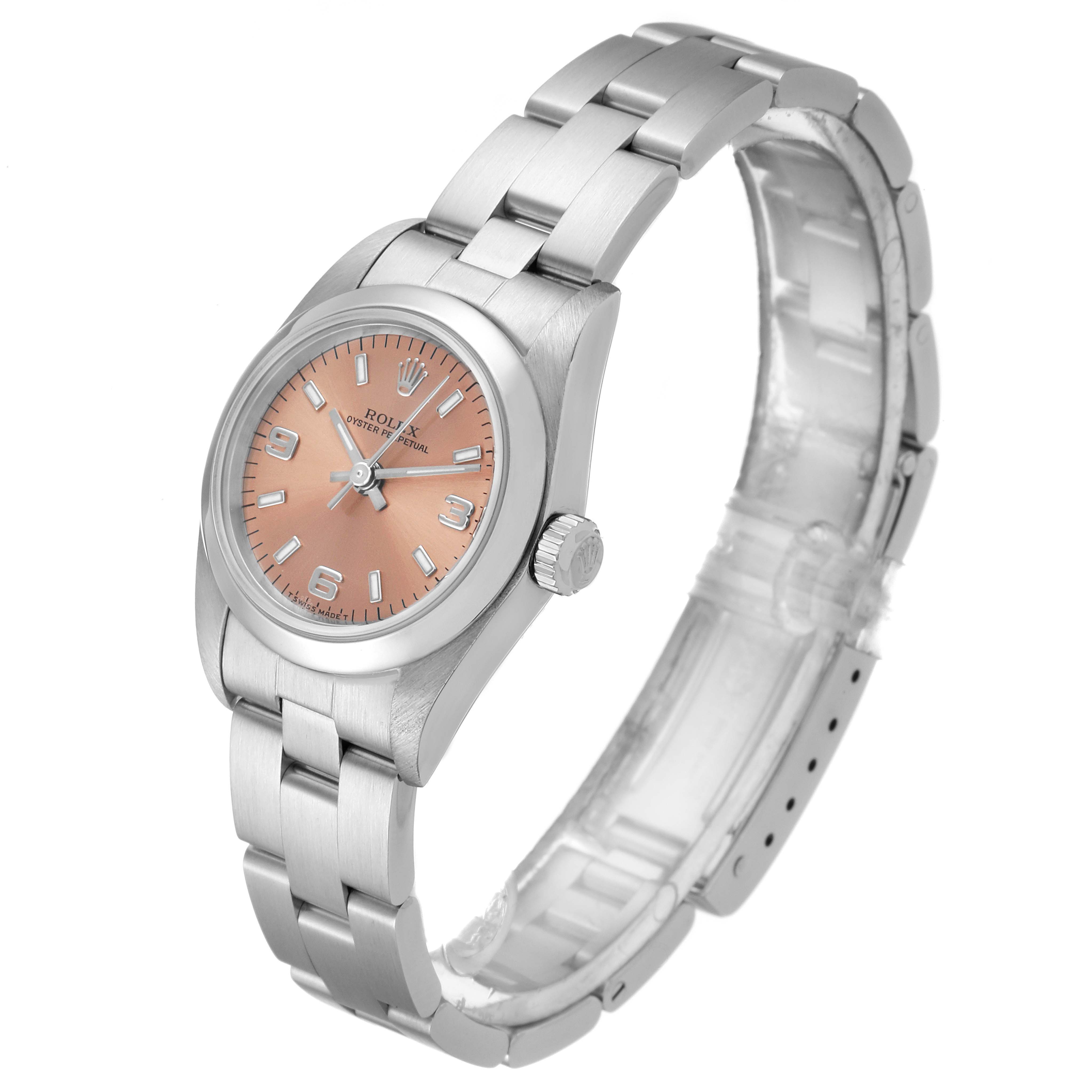 The image shows a side angle of a Rolex Oyster Perpetual 76080 Women's Stainless Steel Pink Dial 76080 Women's Stainless Steel Pink Dial watch with its full band and a salmon-colored dial.
