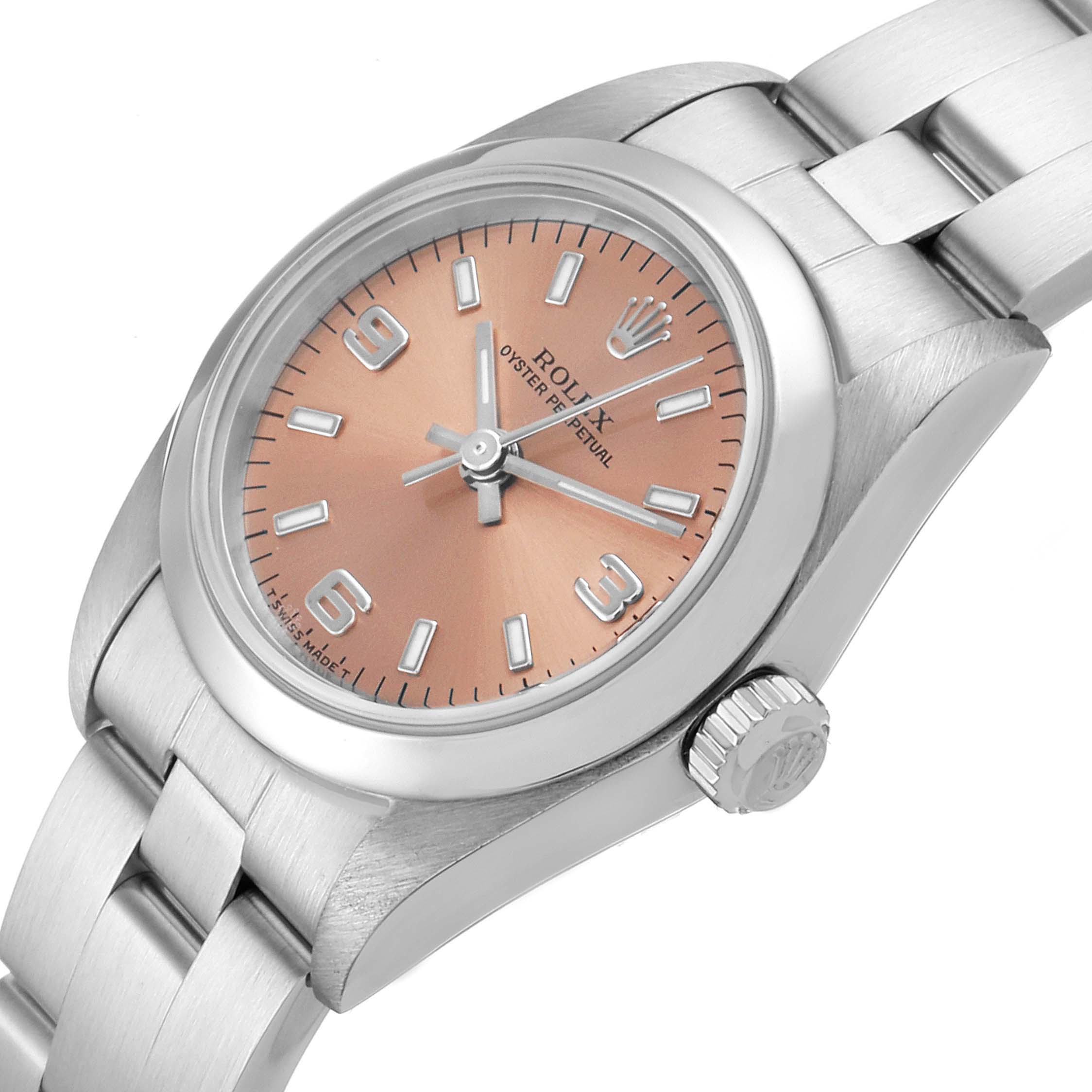 The image shows a close-up of the Rolex Oyster Perpetual 76080 Women's Stainless Steel Pink Dial 76080 Women's Stainless Steel Pink Dial watch displaying its dial, crown, and part of its bracelet.