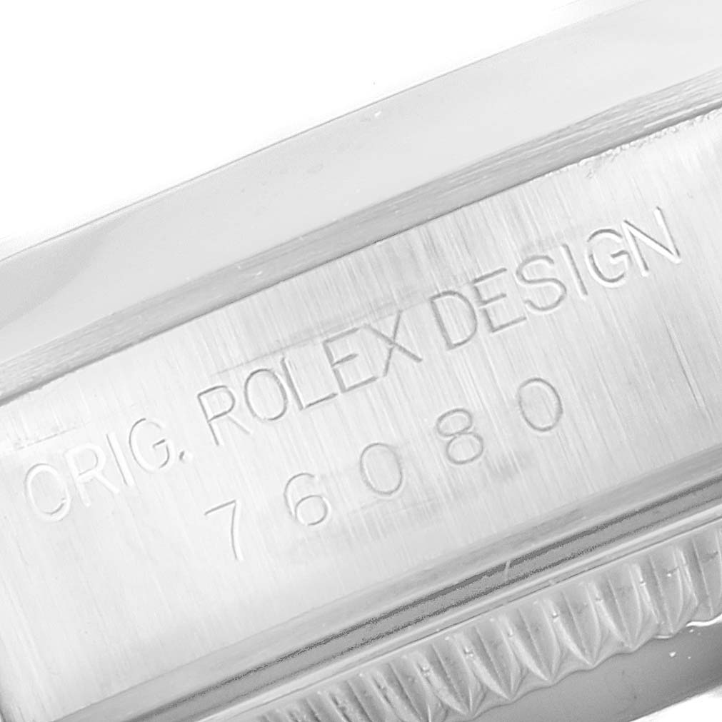 This image shows a close-up of the case side with engravings on the Rolex Oyster Perpetual 76080 Women's Stainless Steel Pink Dial 76080 Women's Stainless Steel Pink Dial watch.