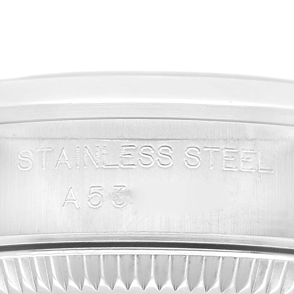 The image shows a close-up of the side case of a Rolex Oyster Perpetual 76080 Women's Stainless Steel Pink Dial 76080 Women's Stainless Steel Pink Dial watch, revealing the "STAINLESS STEEL" engraving.