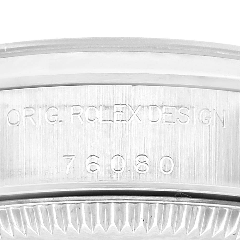 The image shows a close-up of the engraving on the side of the Rolex Oyster Perpetual 76080 Women's Stainless Steel Pink Dial 76080 Women's Stainless Steel Pink Dial model's case.