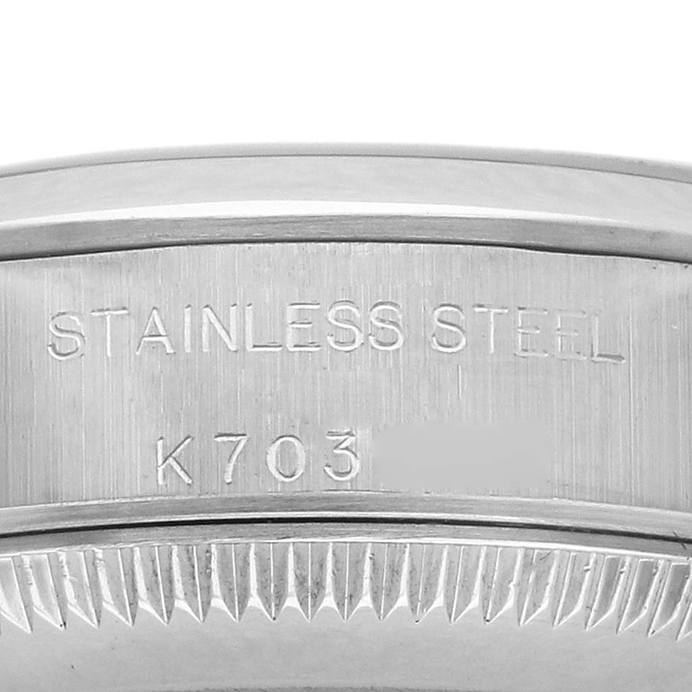 The image shows the side of the Oyster Perpetual by Rolex, highlighting the stainless steel case with engraved details.