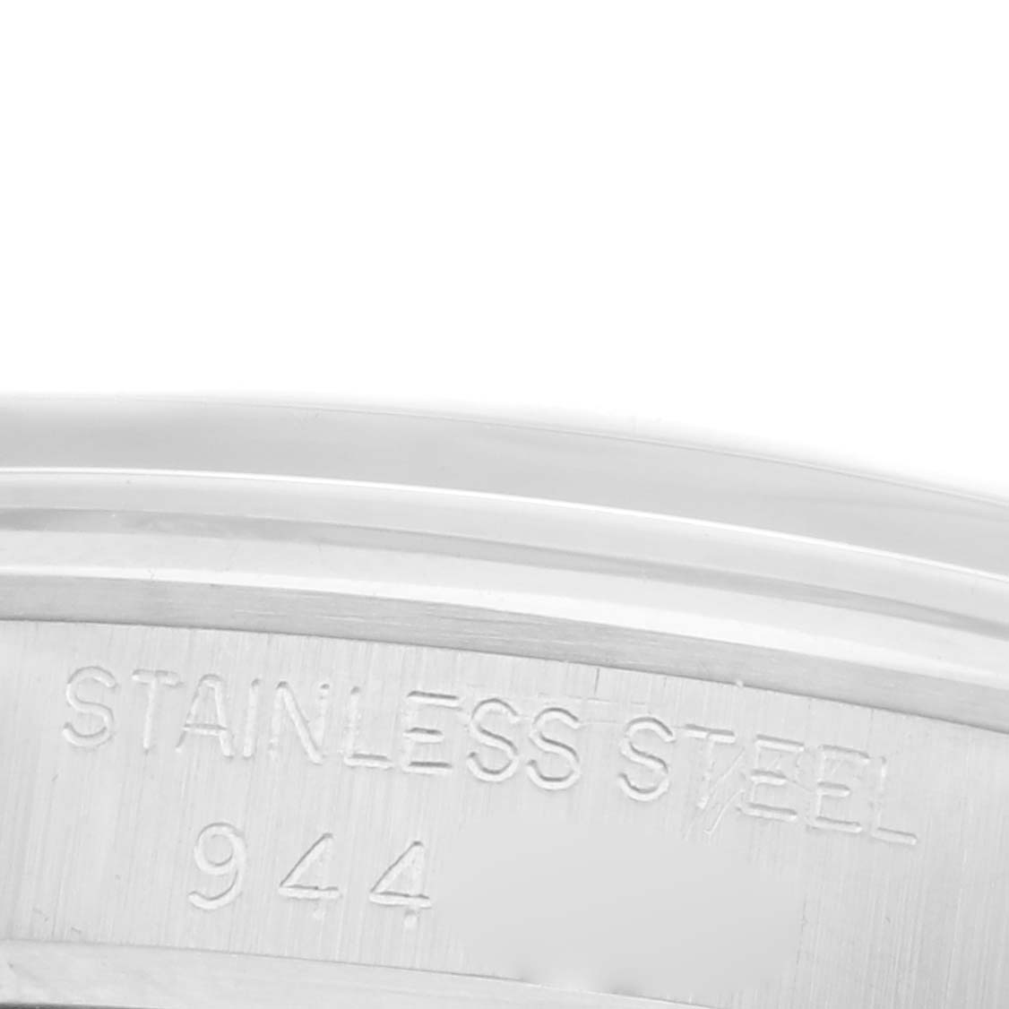 The image shows a close-up of the case back engraving on a Rolex Date 6466 Women's Stainless Steel Silver Dial 6466 Women's Stainless Steel Silver Dial model, indicating "STAINLESS STEEL" and the number "944".