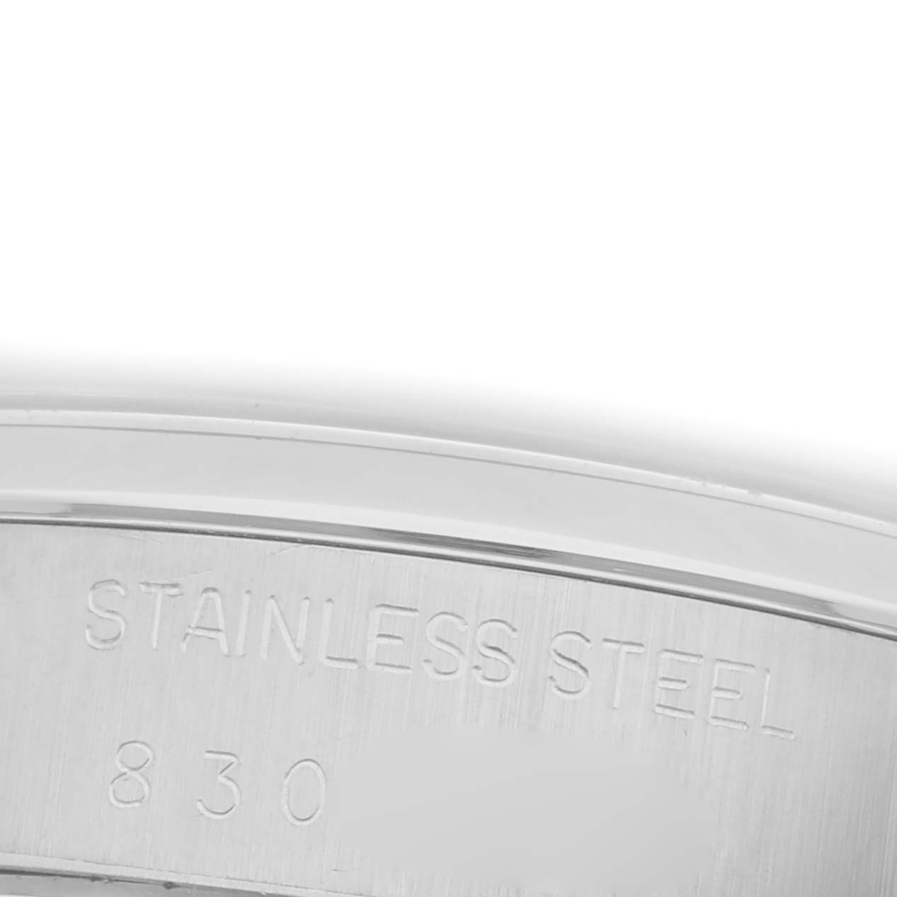 The image shows an angled close-up of the stainless steel inscription on the band of a Rolex Date 6694 Men's Stainless Steel Silver Dial 6694 Men's Stainless Steel Silver Dial watch.