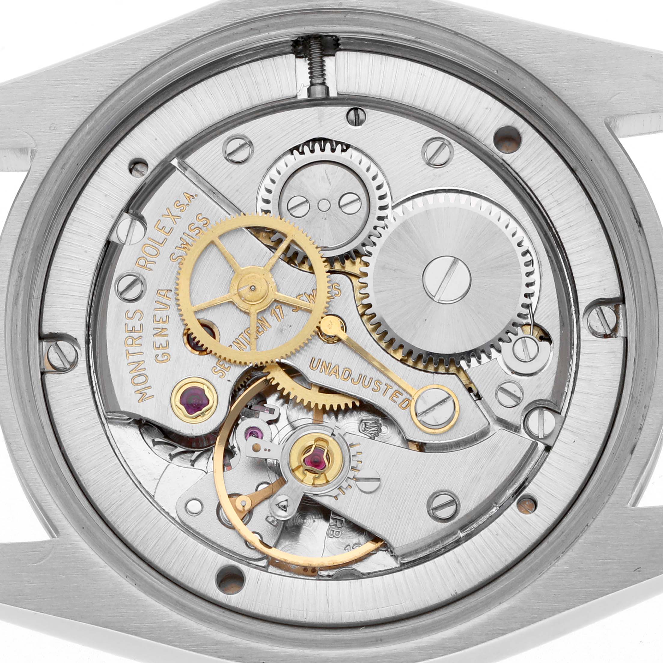 The image shows the Rolex Date 6694 Men's Stainless Steel Silver Dial 6694 Men's Stainless Steel Silver Dial's movement internals from a top-down angle, highlighting gears and intricate parts.
