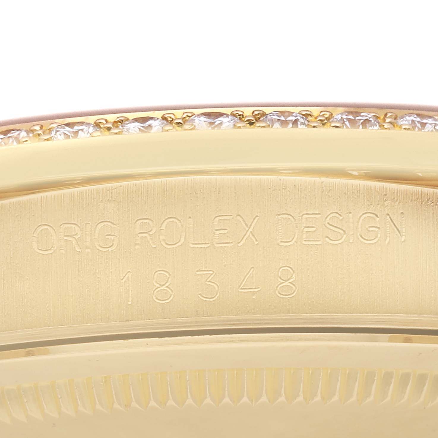 The image shows the serial engraving on the case back edge of a Rolex President 18348 Men
s Yellow Gold Champagne Dial 18348 Men
s Yellow Gold Champagne Dial model watch, along with part of the diamond bezel.