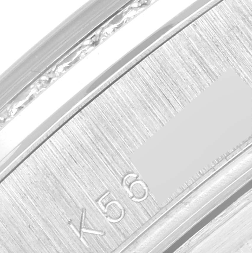This close-up image shows part of the outer casing and serial number of the Rolex President 118346 Men's Platinum Silver Dial 118346 Men's Platinum Silver Dial model watch.