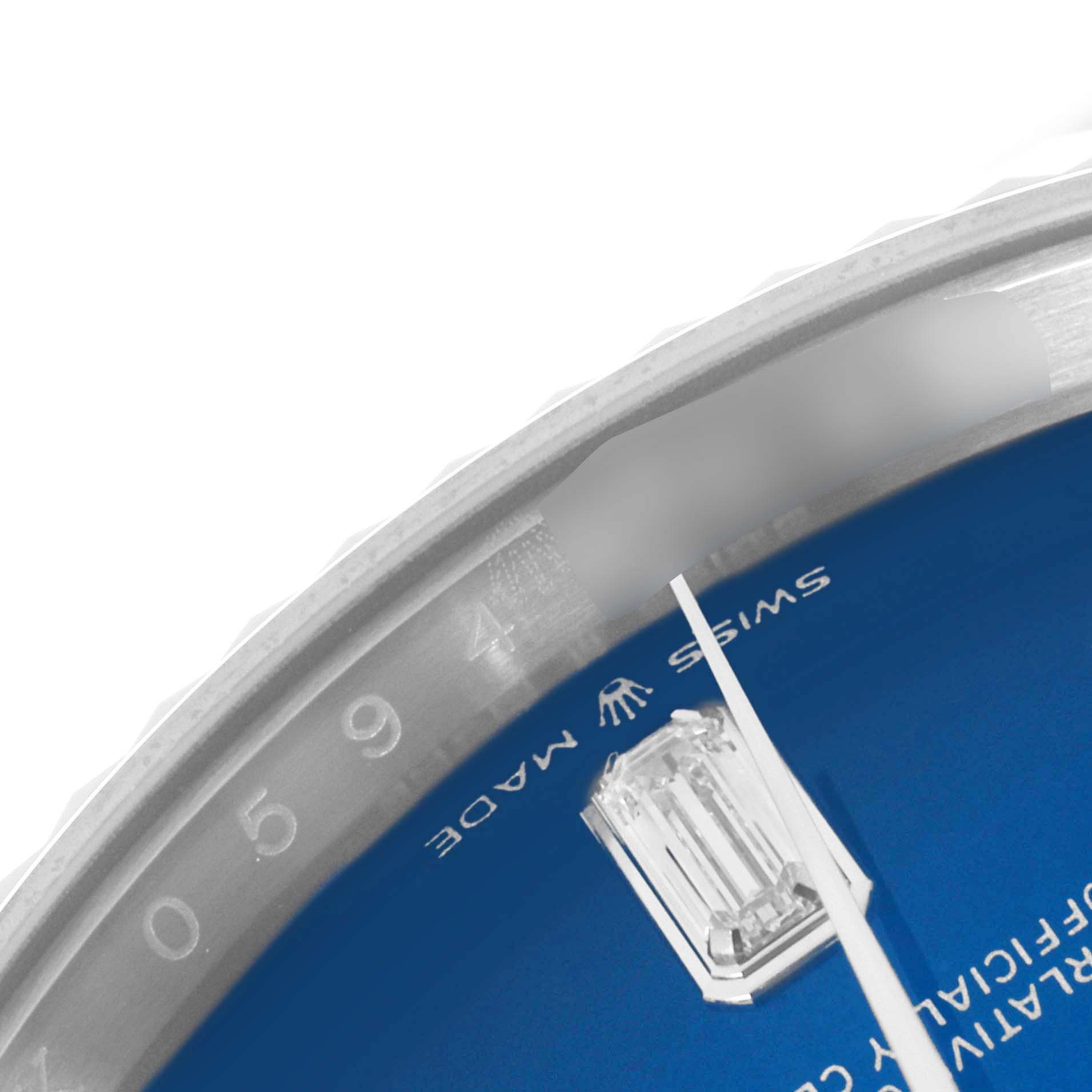 The image shows a close-up of the Rolex President 128239 Men
s White Gold Blue Dial 128239 Men
s White Gold Blue Dial watch
s blue dial and diamond marker, captured at an angle.