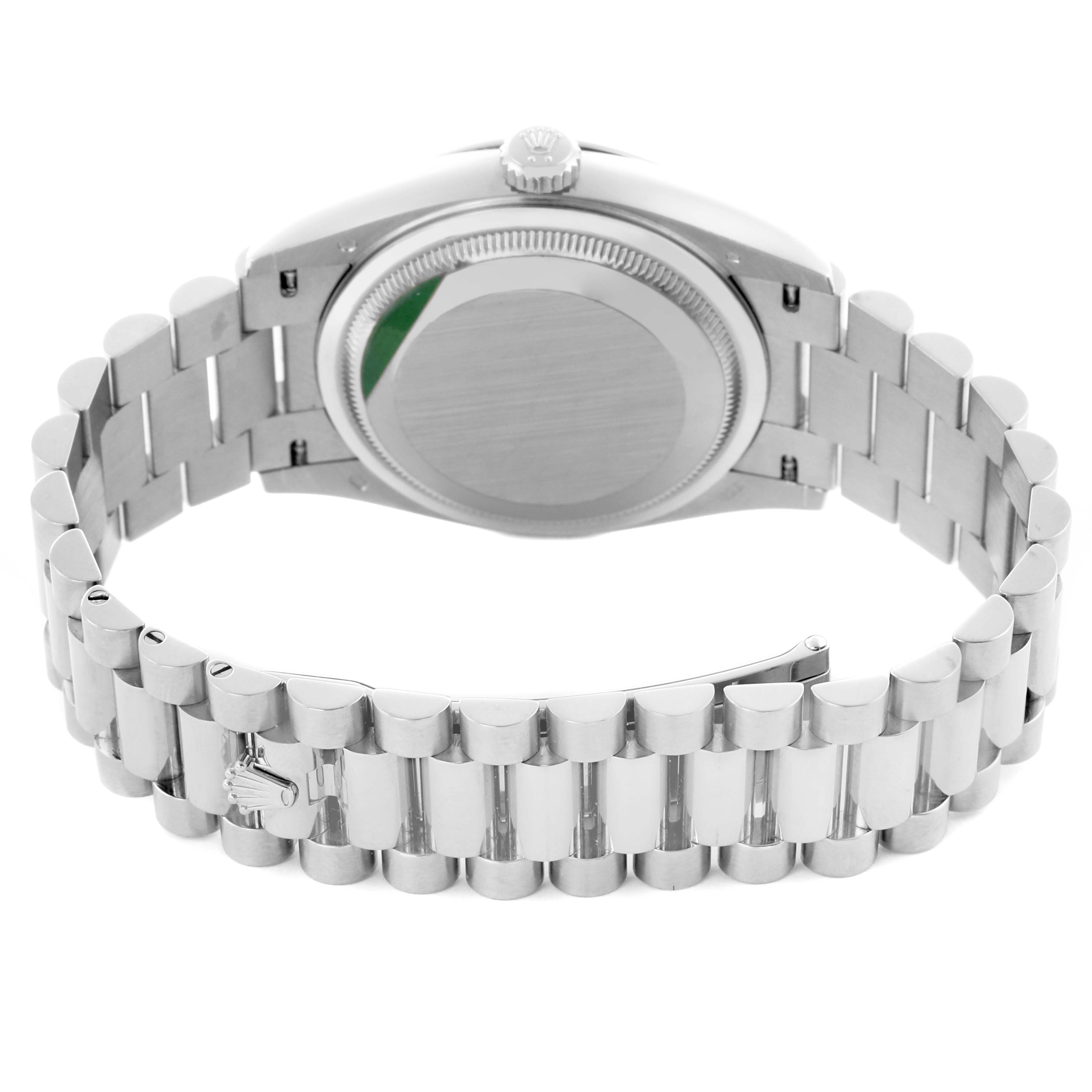 The image shows the back view of a Rolex President 128239 Men
s White Gold Blue Dial 128239 Men
s White Gold Blue Dial watch, featuring the case back, crown, and the bracelet with a clasp.