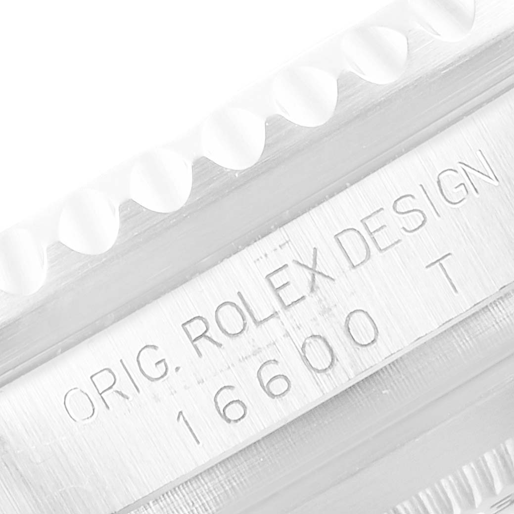 The image shows a close-up of the bezel teeth and the engraved case side of a Rolex Sea-Dweller 16600 Men
s Stainless Steel Black Dial 16600 Men
s Stainless Steel Black Dial model.