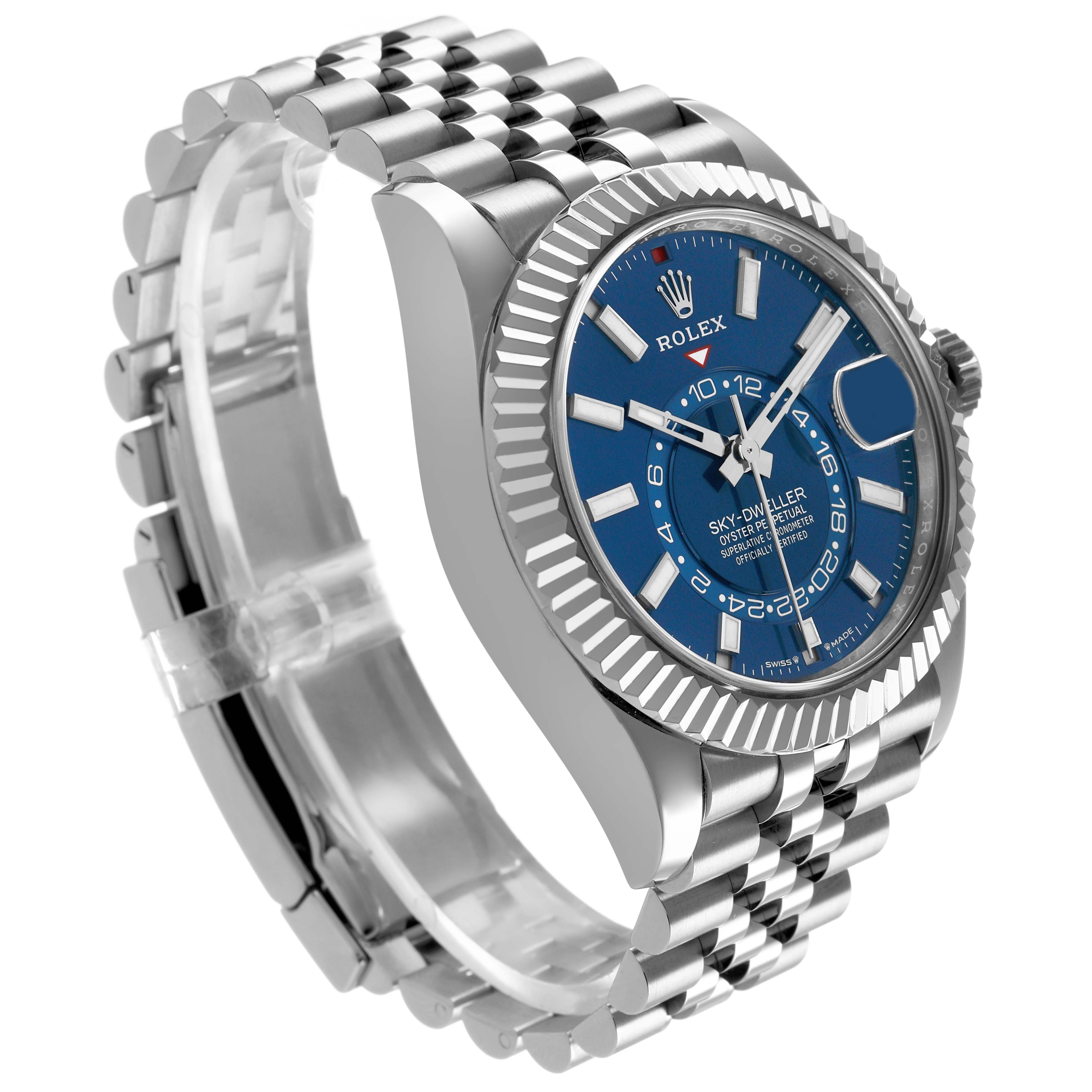 The Rolex Sky-Dweller 336934 Men's Stainless Steel Blue Dial watch is shown from a front-left angle, highlighting its blue dial, fluted bezel, and Jubilee bracelet.