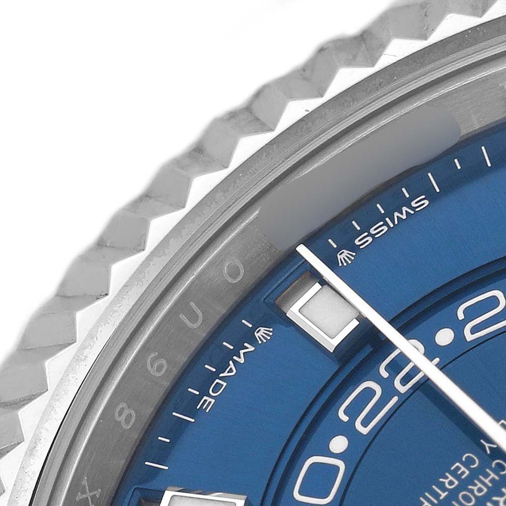 This close-up image shows the bezel and part of the blue dial of a Rolex Sky-Dweller 336934 Men's Stainless Steel Blue Dial, highlighting the watch's markers and text.