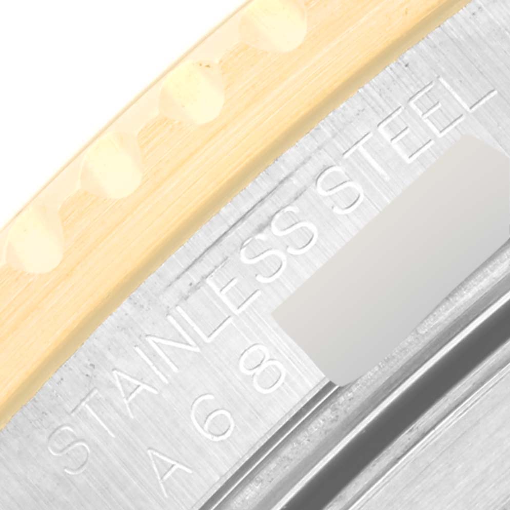 The image shows a close-up of the edge of a Rolex Submariner 16613 Men's Steel and Gold (two tone) Blue Dial 16613 Men's Steel and Gold (two tone) Blue Dial watch, displaying part of the bezel and the stainless steel marking.