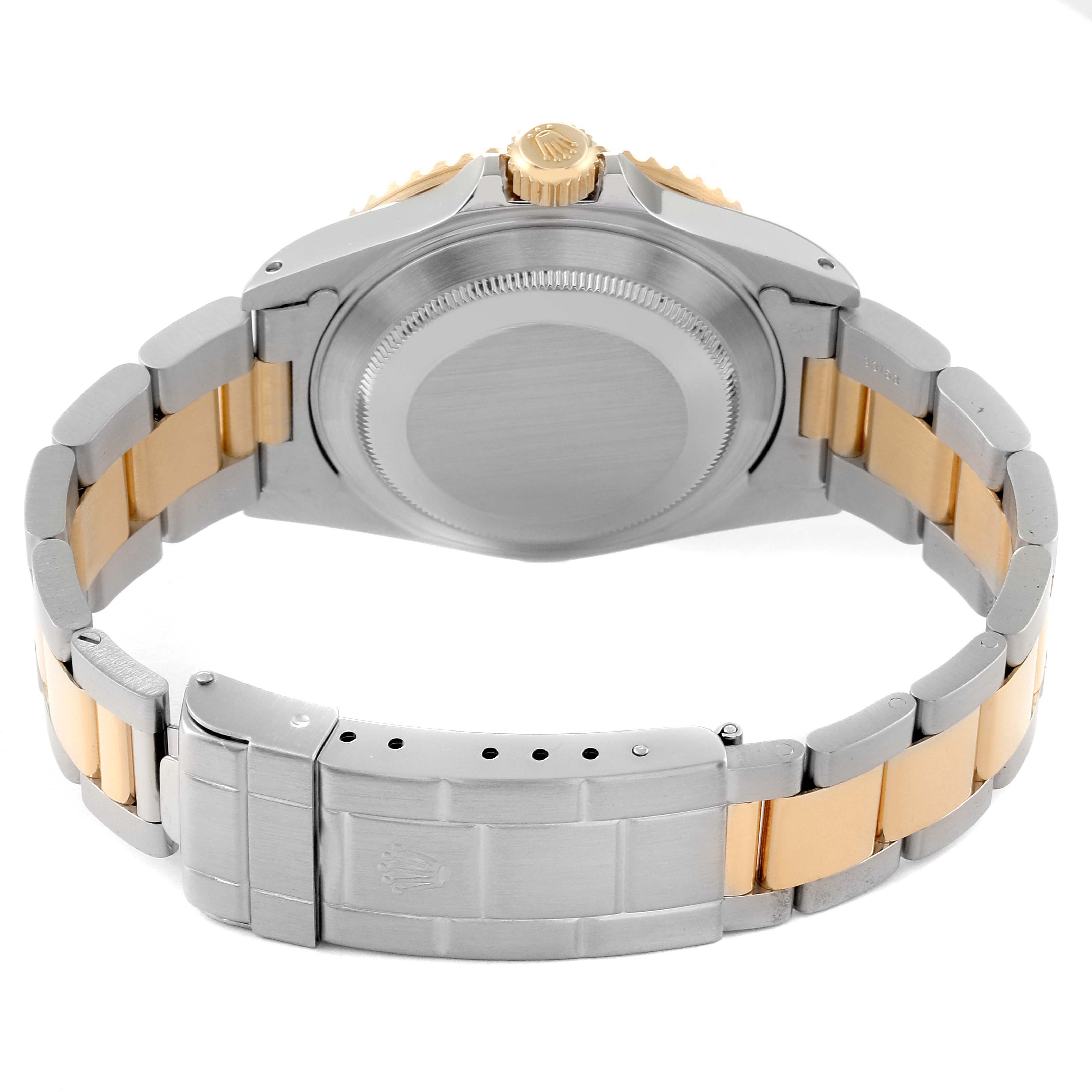 The image shows the back of a Rolex Submariner 16613 Men's Steel and Gold (two tone) Blue Dial 16613 Men's Steel and Gold (two tone) Blue Dial watch, highlighting its case back and two-tone bracelet.