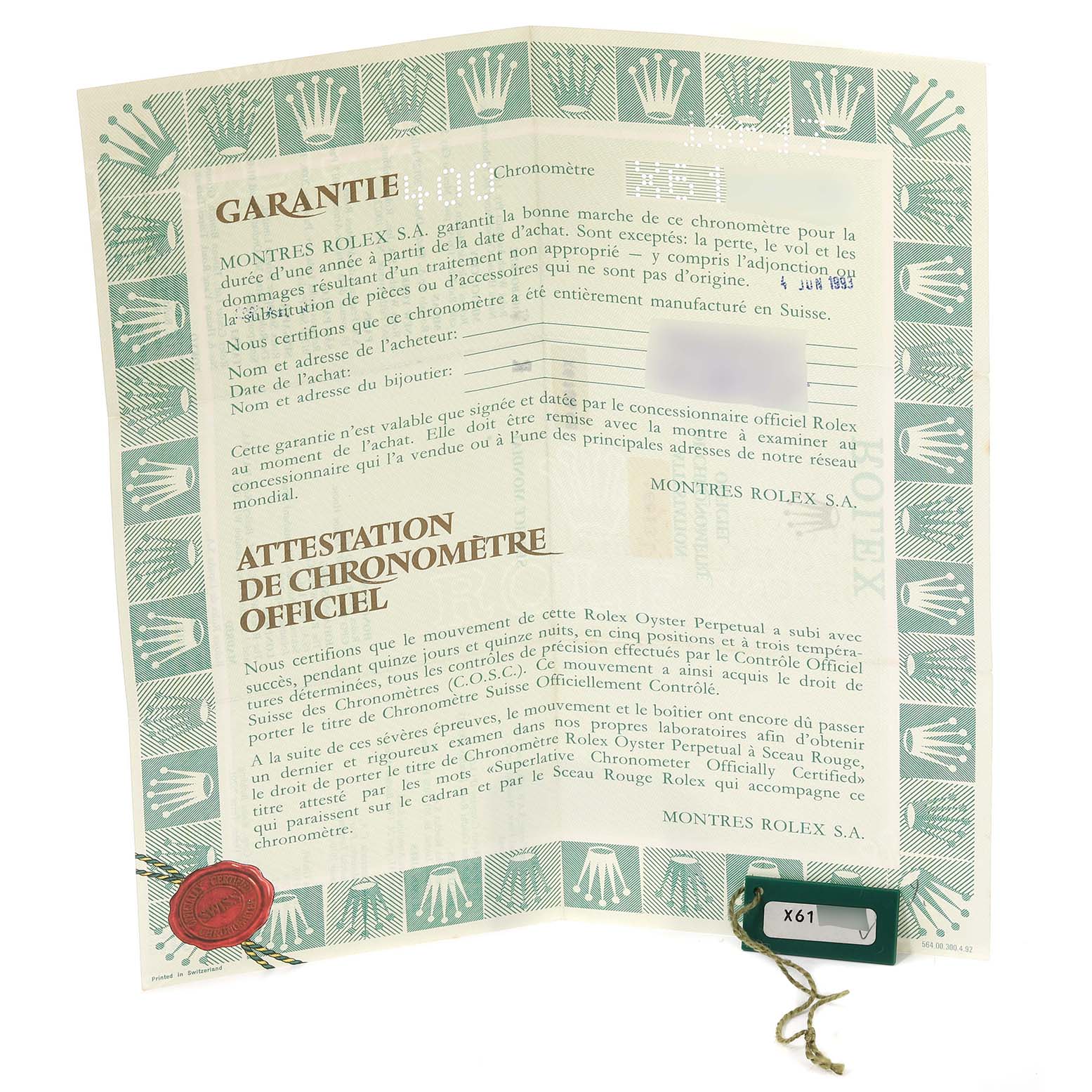 The image shows a Rolex Submariner 16613 Men's Steel and Gold (two tone) Blue Dial 16613 Men's Steel and Gold (two tone) Blue Dial warranty certificate, displaying the official documentation and a green tag.