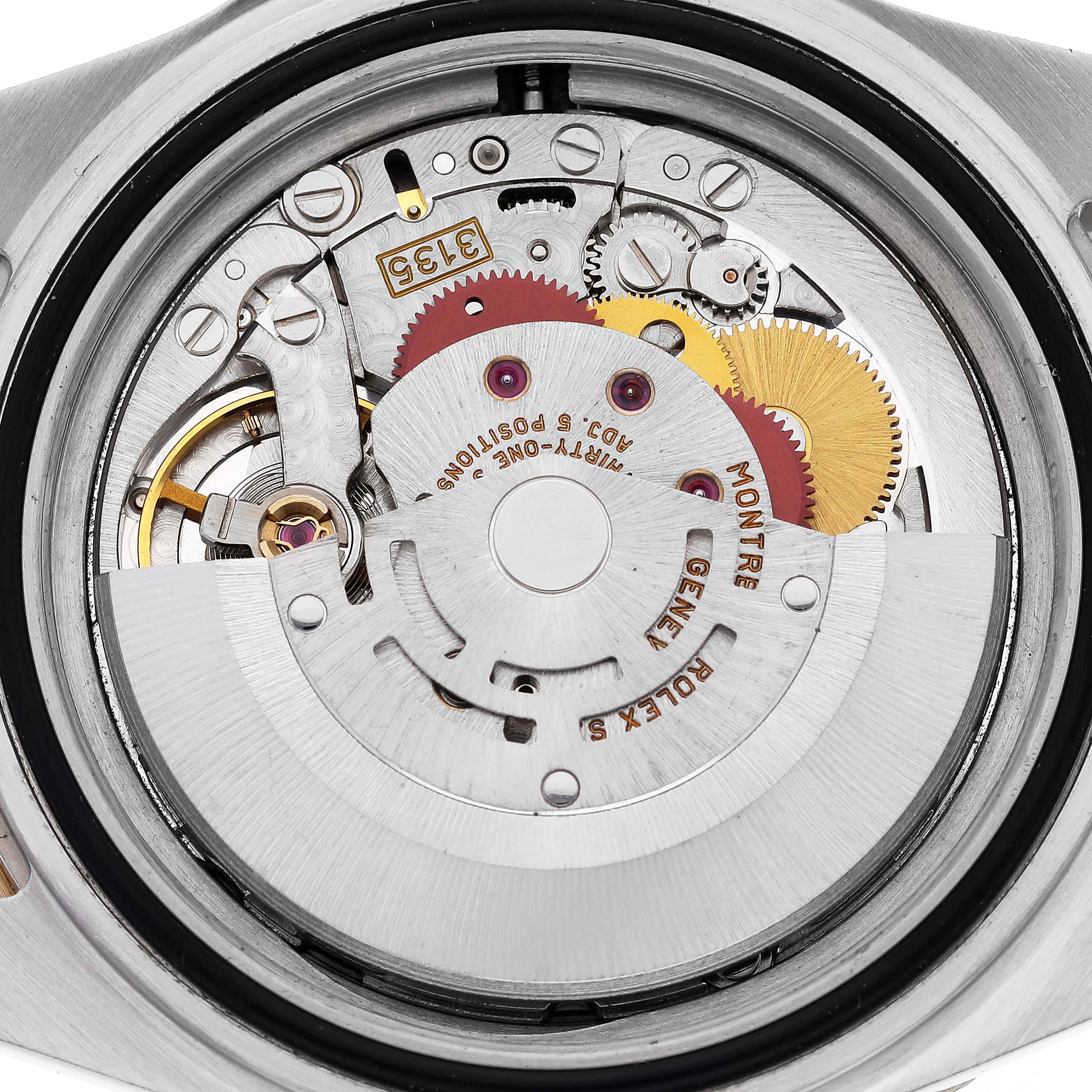 This image shows the internal movement of a Rolex Submariner 16613 Men's Steel and Gold (two tone) Blue Dial 16613 Men's Steel and Gold (two tone) Blue Dial watch from the back, including gears and intricate mechanisms.