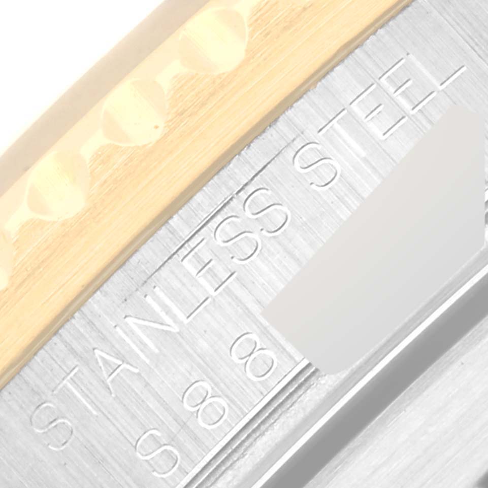 This close-up image shows the engraved "STAINLESS STEEL" on the edge of a Rolex Submariner 16613 Men's Steel and Gold (two tone) Blue Dial 16613 Men's Steel and Gold (two tone) Blue Dial watch bezel.