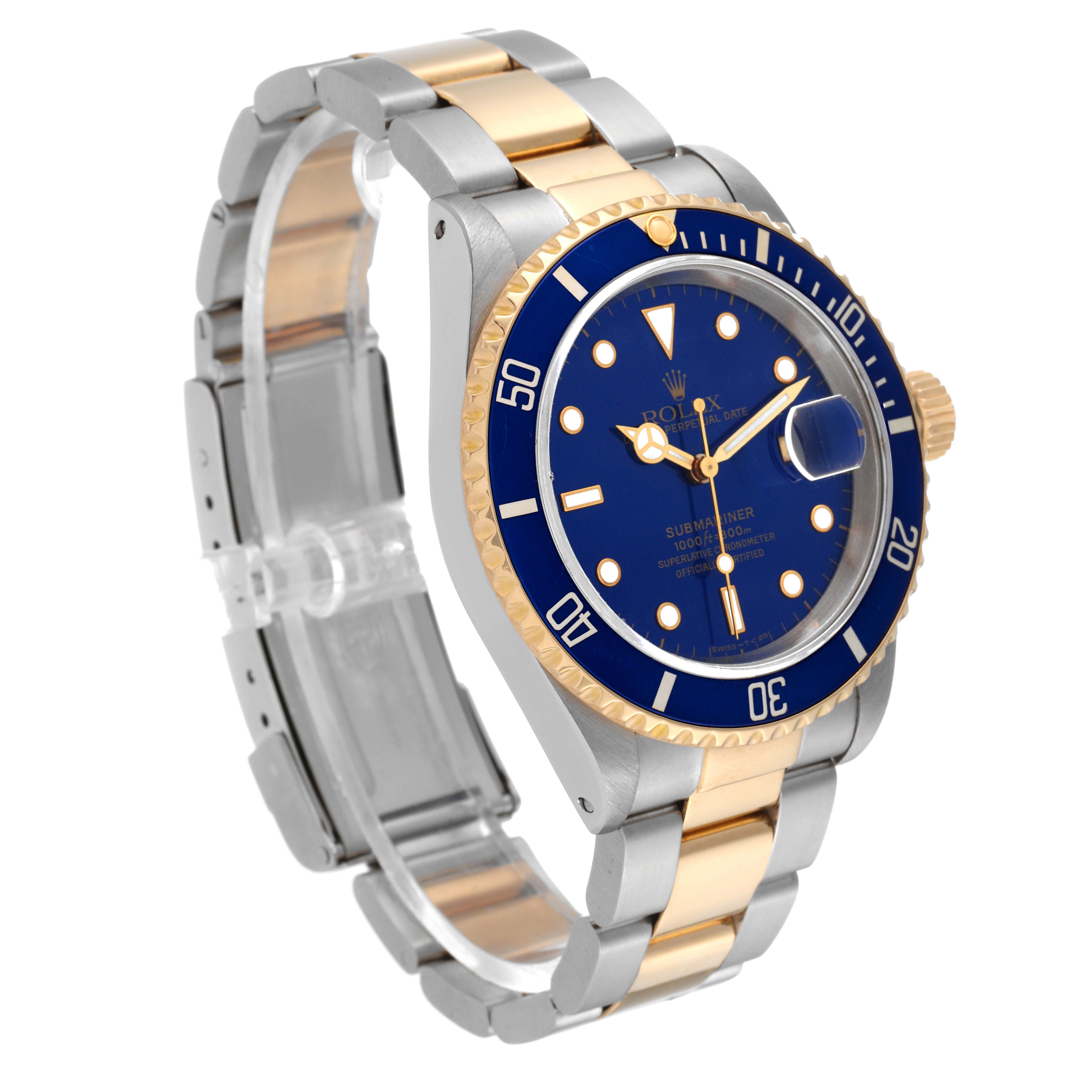 The image shows a Rolex Submariner 16613 Men's Steel and Gold (two tone) Blue Dial 16613 Men's Steel and Gold (two tone) Blue Dial at a three-quarter angle, displaying its blue dial, bezel, and two-tone bracelet.
