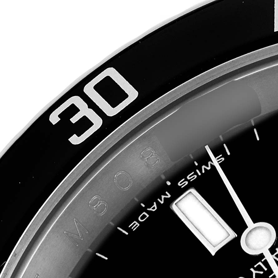 The image shows a close-up of the bezel and part of the dial of the Rolex Submariner 16610 Men
s Stainless Steel Black Dial 16610 Men
s Stainless Steel Black Dial watch, highlighting the "30" marker and "Swiss Made" text.