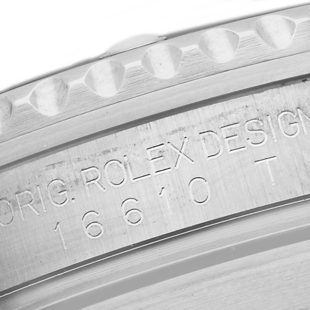 The image shows a close-up of the engraving on the side of the casing of the Rolex Submariner 16610 Men
s Stainless Steel Black Dial 16610 Men
s Stainless Steel Black Dial watch, model 16610.