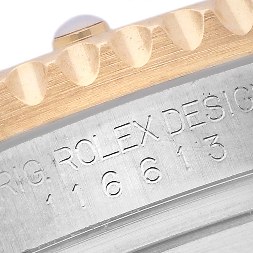 The image shows a close-up of the bezel and engraved design number on a Rolex Submariner 116613LB Men's Steel and Gold (two tone) Blue Dial 116613LB Men's Steel and Gold (two tone) Blue Dial watch.
