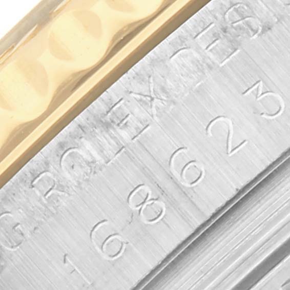 The image shows a close-up of the Rolex Yacht-Master 168623 Men
s Steel and Gold (two tone) White Dial 168623 Men
s Steel and Gold (two tone) White Dial watch
s bezel and engraved details.