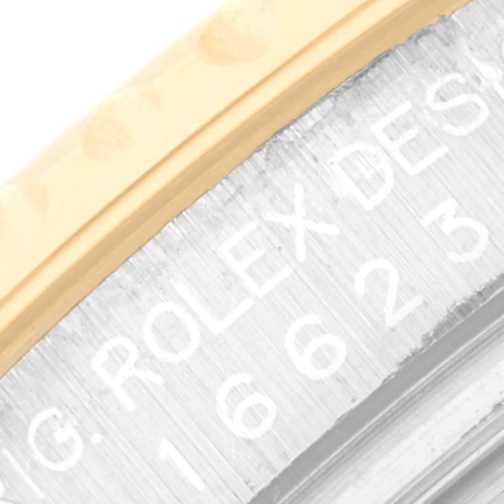 This close-up angle of the Rolex Yacht-Master 16623 Men's Steel and Gold (two tone) Champagne Dial 16623 Men's Steel and Gold (two tone) Champagne Dial watch shows part of the bezel and the engraved reference number.