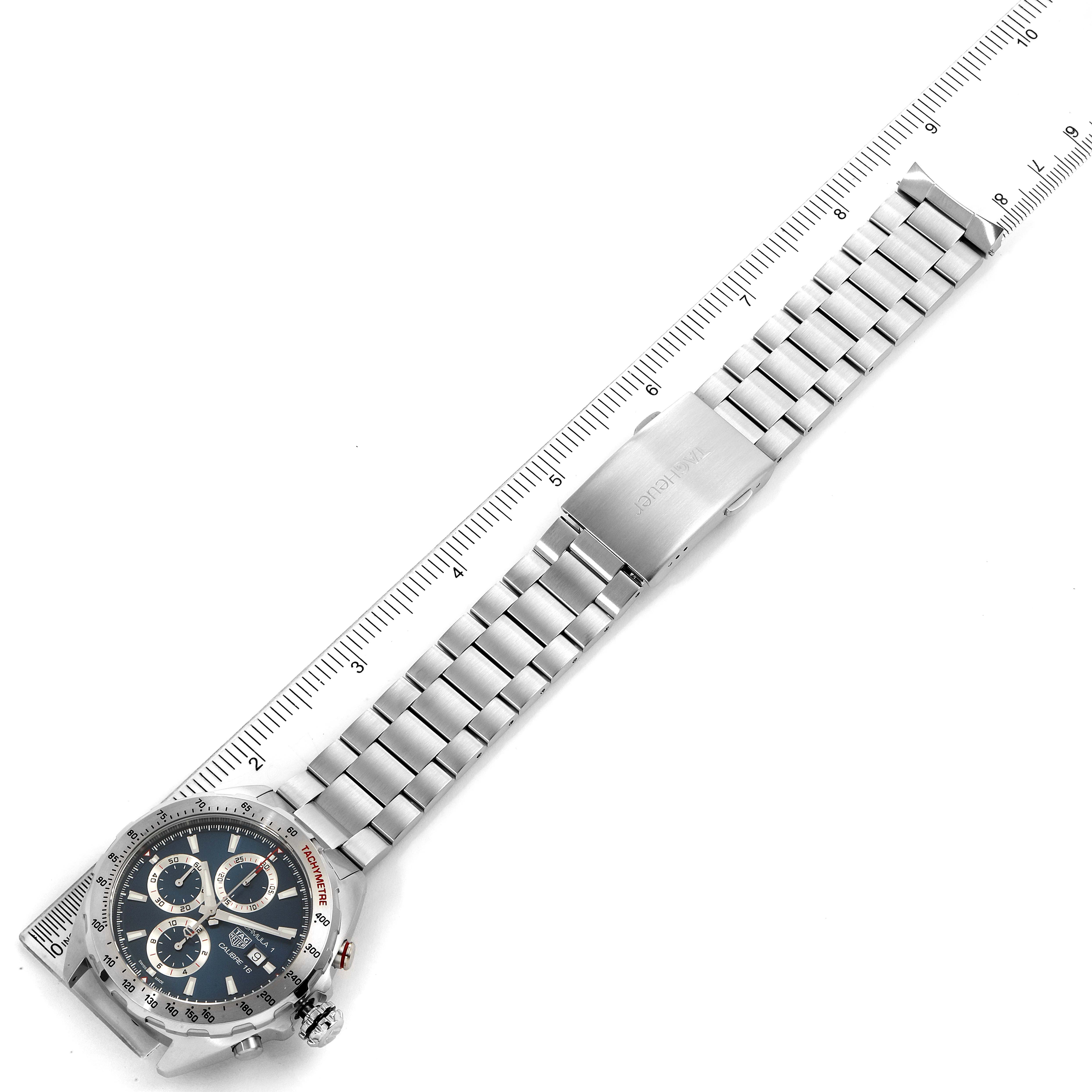 The image shows a Tag Heuer Formula 1 CAZ2015.BA0876 Men's Stainless Steel Blue Dial CAZ2015.BA0876 Men's Stainless Steel Blue Dial model watch fully extended with a ruler beside it.