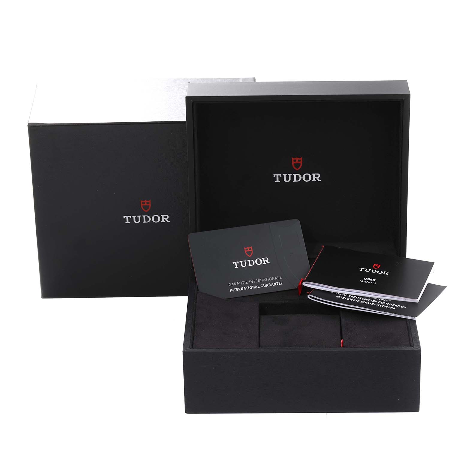 The image shows the packaging and documentation (warranty card and booklets) for a Tudor Heritage Black Bay 79363N Men
s Steel and Gold (two tone) Black Dial 79363N Men
s Steel and Gold (two tone) Black Dial watch.