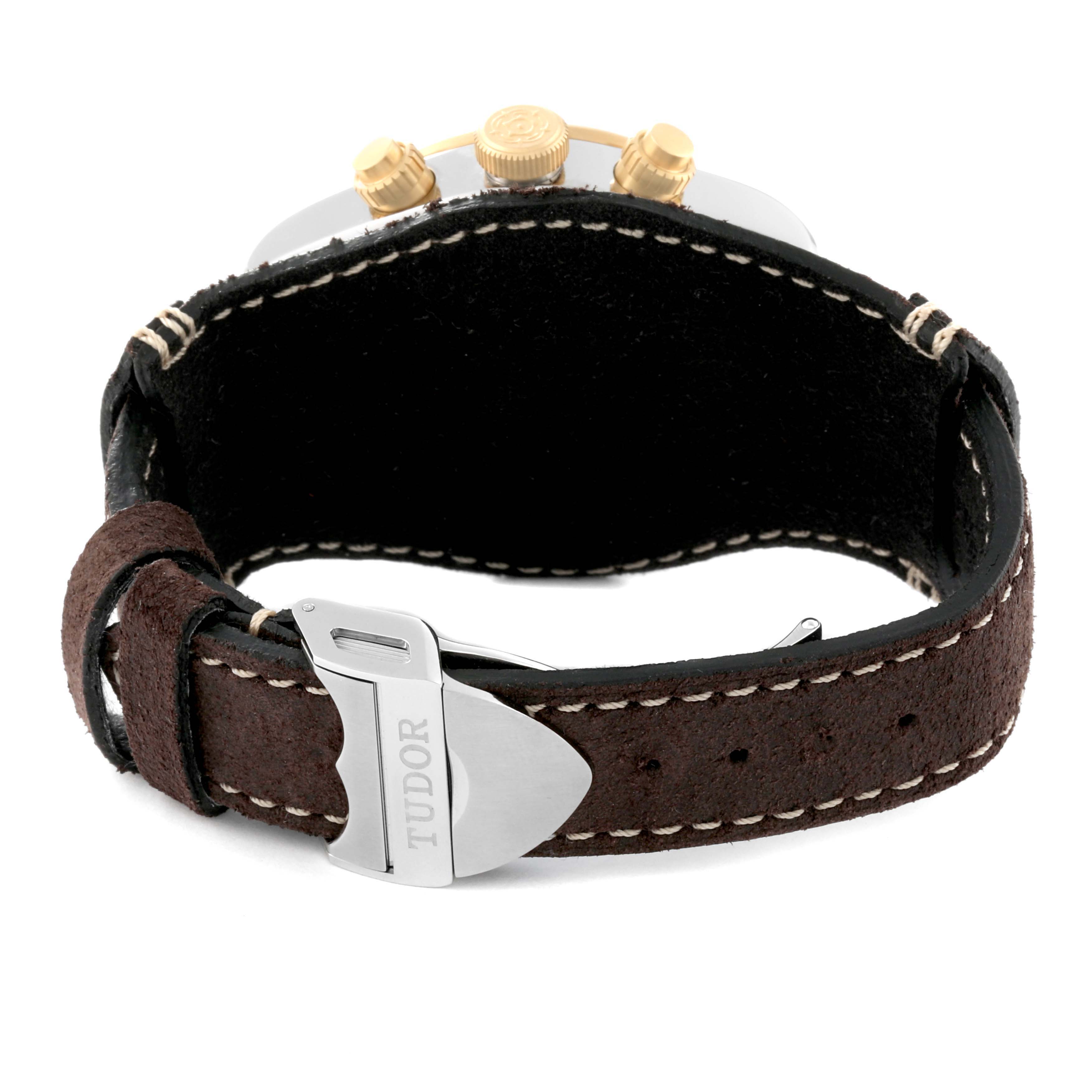The image shows the back of the Tudor Heritage Black Bay 79363N Men
s Steel and Gold (two tone) Black Dial 79363N Men
s Steel and Gold (two tone) Black Dial watch, focusing on the brown leather strap and clasp.