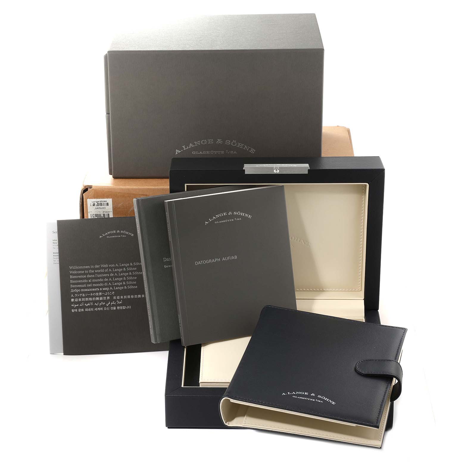 The image shows the packaging, manuals, and a leather booklet for the A. Lange 
Sohne Datograph 405.035 Men
s Platinum Black Dial watch model from a frontal angle.
