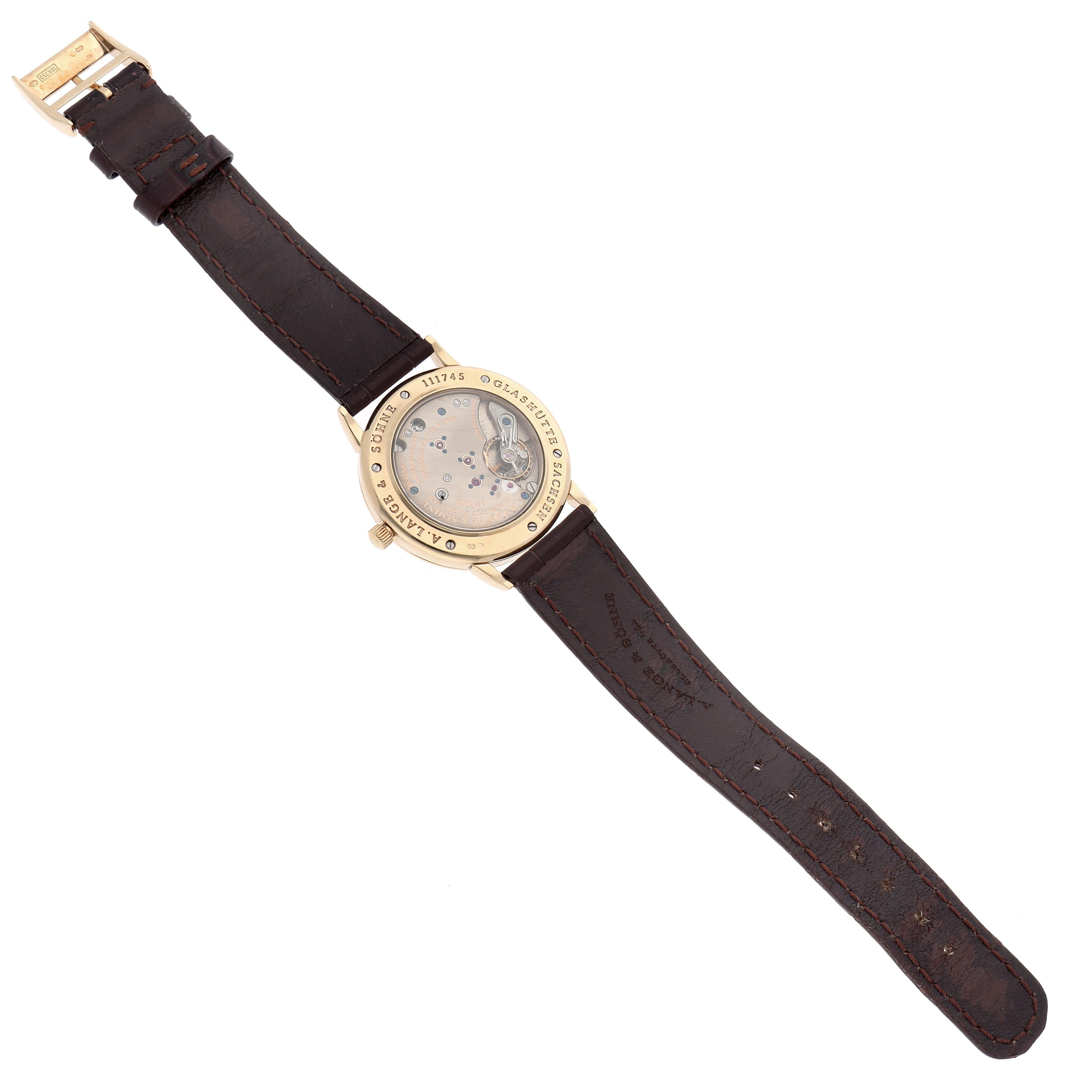 The image shows the back of the A. Lange & Sohne 1815 206.021 Men's Yellow Gold Silver Dial watch, highlighting the movement and leather strap.