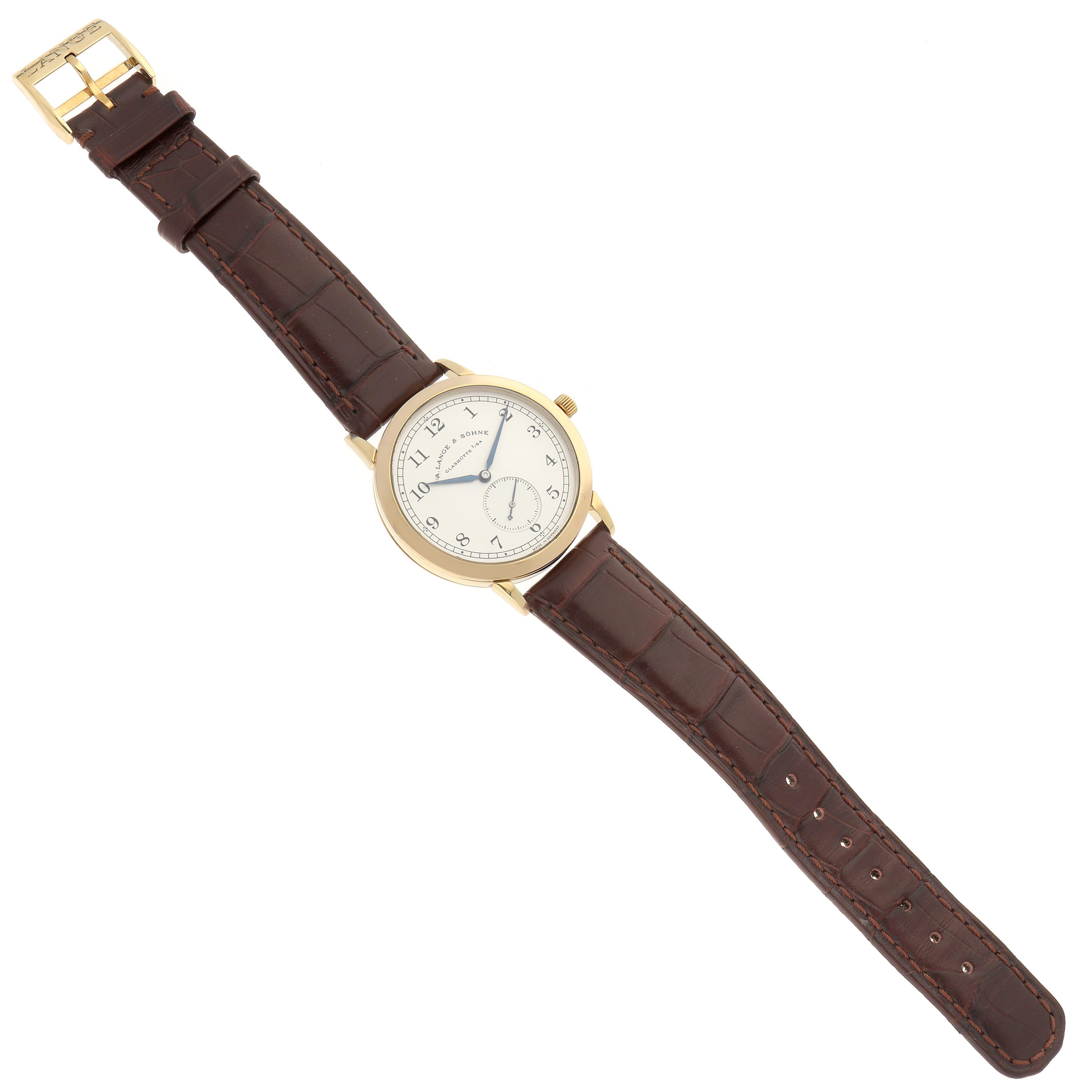 The A. Lange & Sohne 1815 206.021 Men's Yellow Gold Silver Dial watch is shown from a top-down view, displaying the face, hands, and brown leather strap.