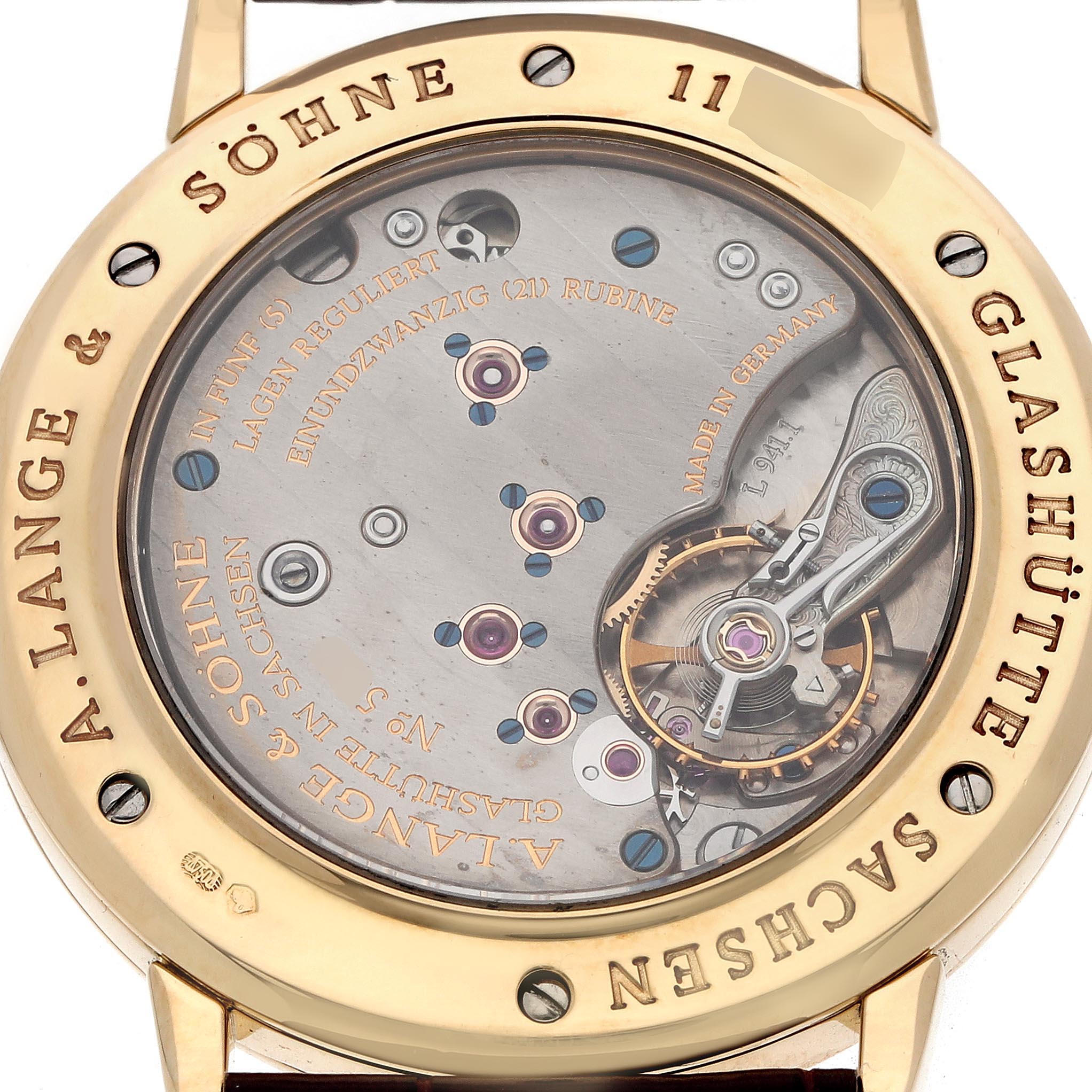 The image shows the back view of the A. Lange & Sohne 1815 206.021 Men's Yellow Gold Silver Dial, highlighting its intricate movement and detailing.
