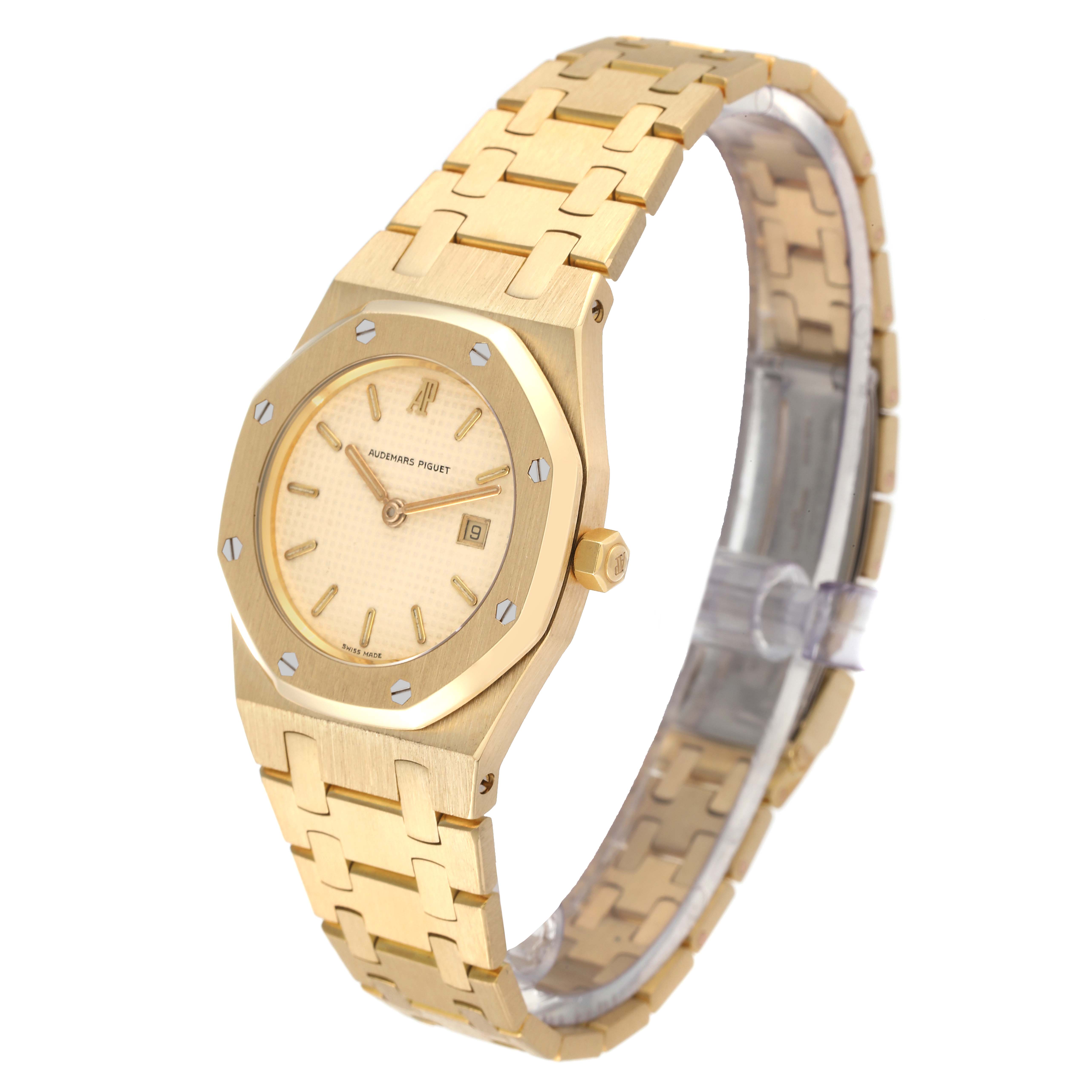 The image shows the Audemars Piguet Royal Oak Women's Yellow Gold Beige Dial Women's Yellow Gold Beige Dial watch at a three-quarter angle, highlighting the face, bezel, bracelet, and crown.