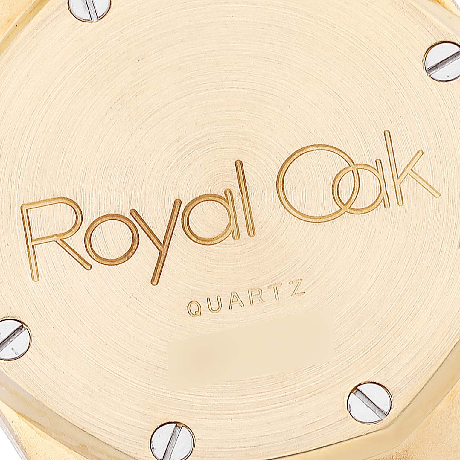 This image shows a close-up view of the back case of a Royal Oak model by Audemars Piguet, highlighting the engraved logo and screws.