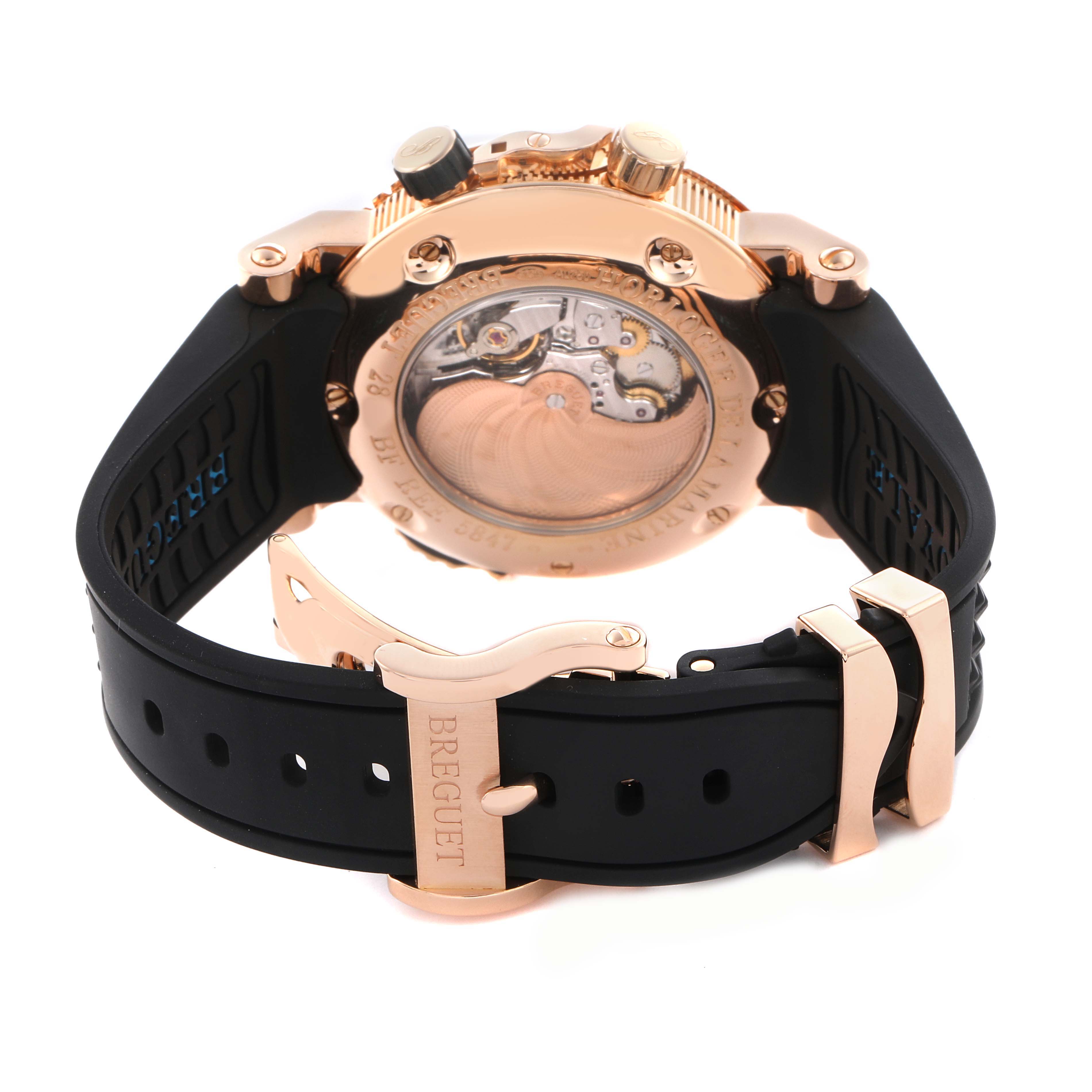 The Breguet Marine 5847BR/Z2/5ZV Men's Rose Gold Black Dial 5847BR/Z2/5ZV Men's Rose Gold Black Dial watch is shown from the back, highlighting the case back, movement, and black strap with a clasp.