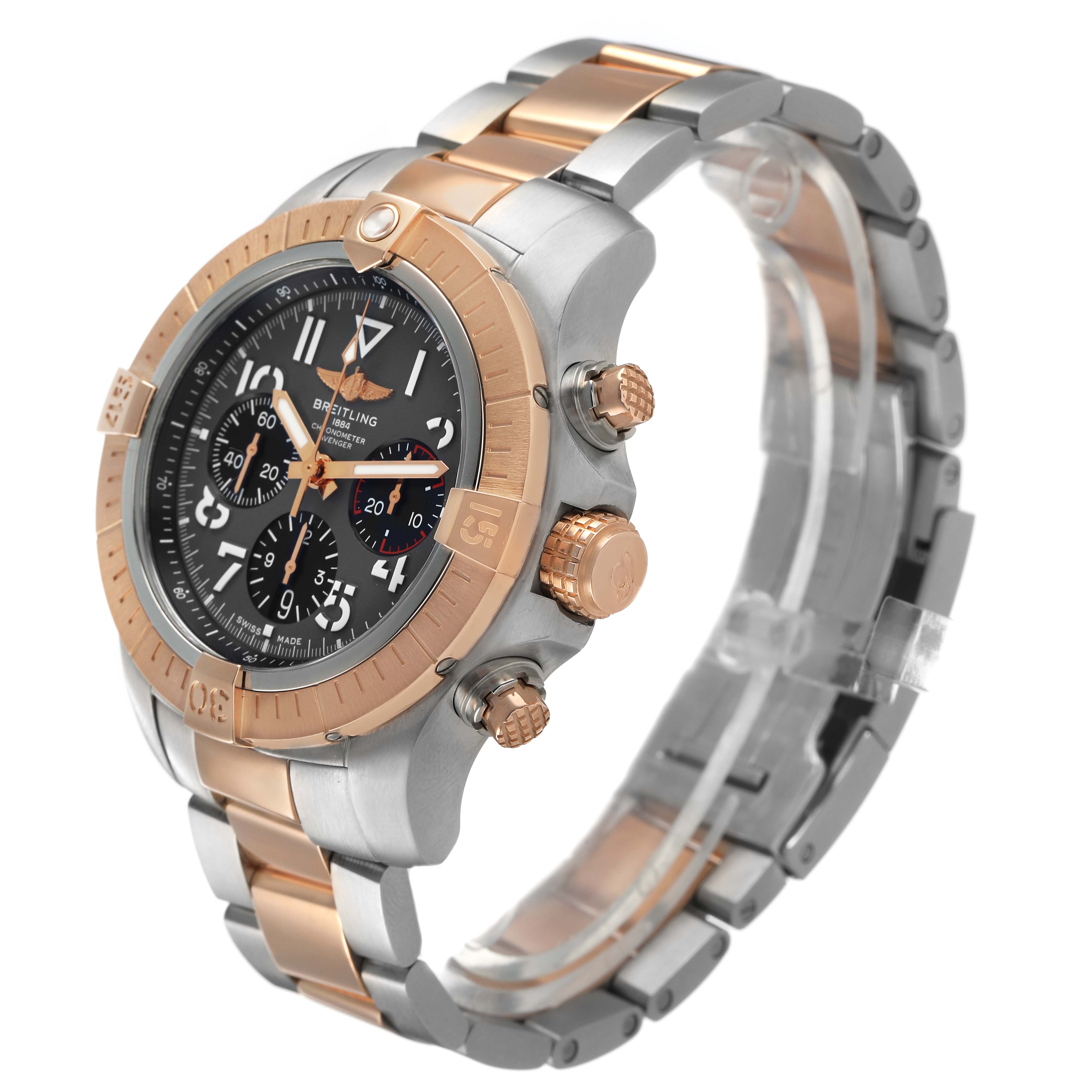 The Breitling Avenger UB01821A1B1U1 Men's Steel and Gold (two tone) Grey Dial watch is shown at a three-quarter angle, highlighting the bezel, crown, chronograph buttons, and metal bracelet.