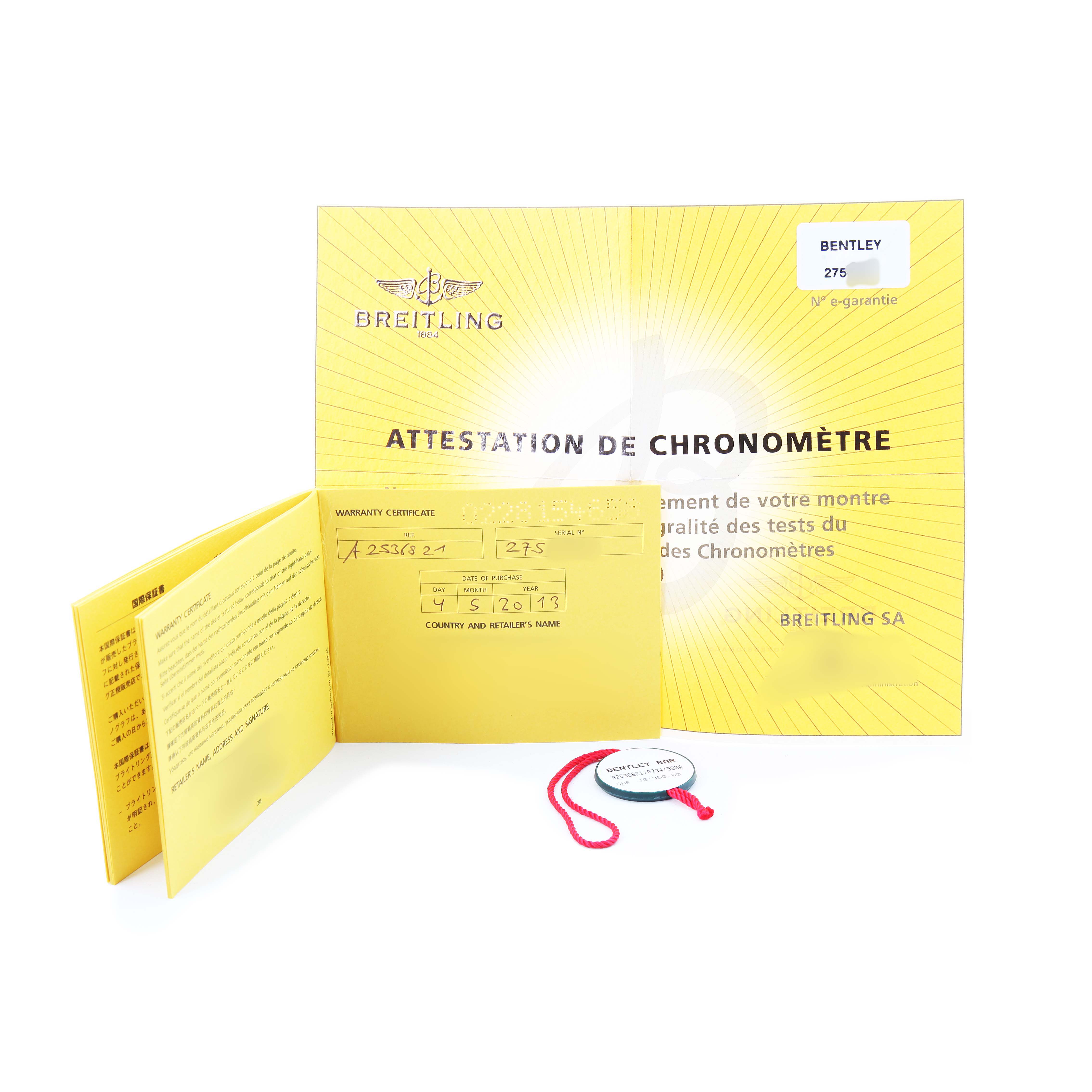 The image shows the warranty certificate and documentation for a Breitling Bentley A25368 Men's Stainless Steel Silver Dial watch, along with a tag, laid out flat.