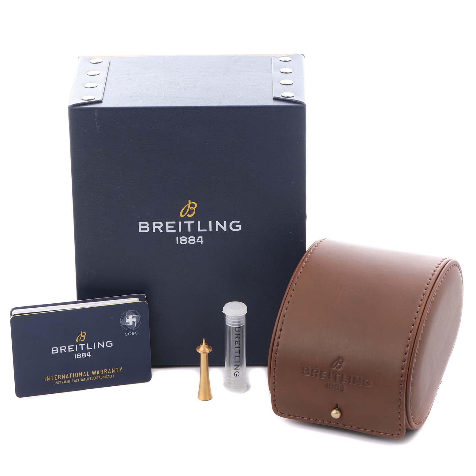 The image shows accessories for the Breitling Premier AB2510 Men's Stainless Steel Pink Dial AB2510 Men's Stainless Steel Pink Dial model, including a box, leather case, warranty card, pin, and a small tube.